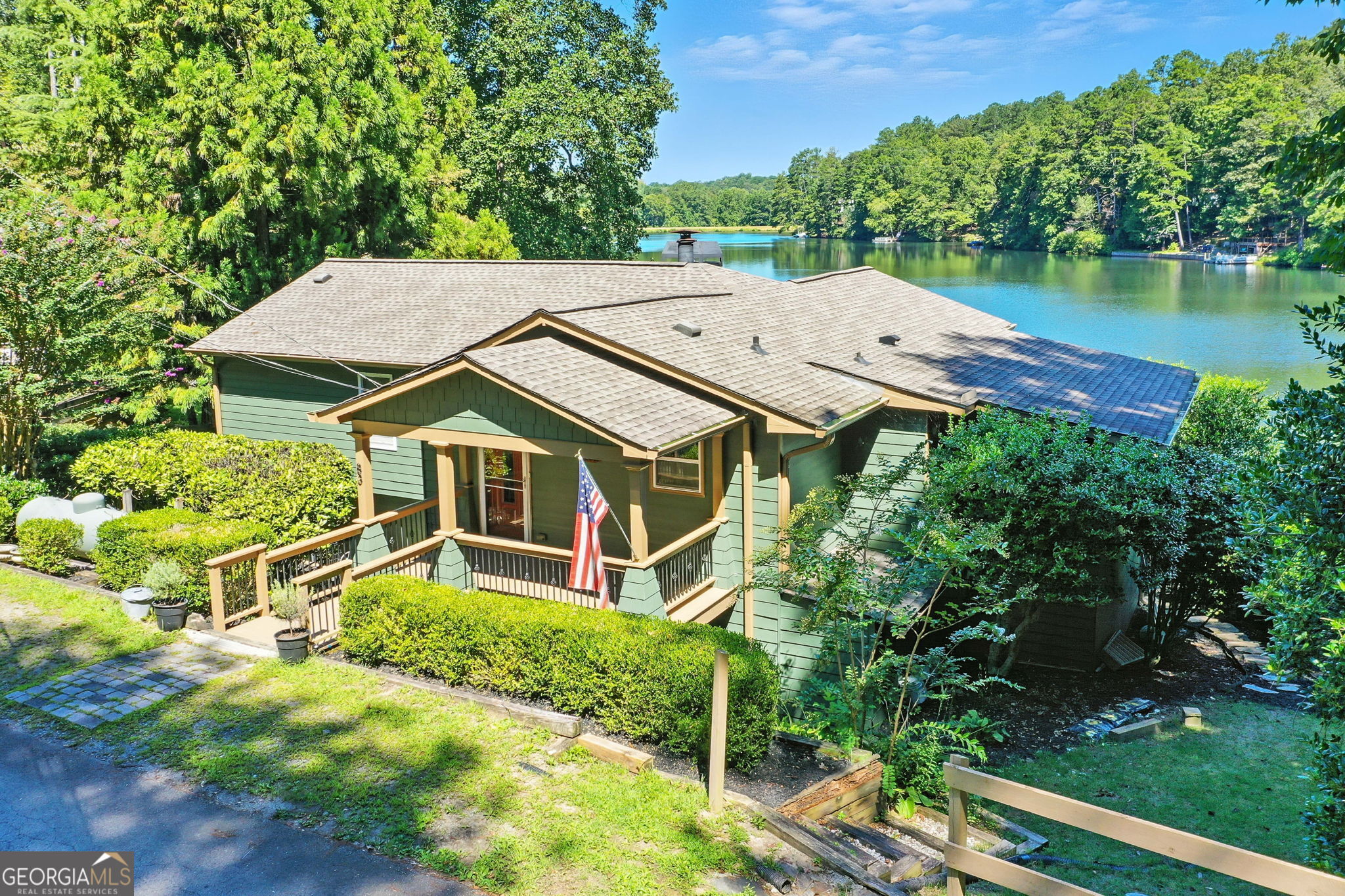 Looking for a hidden gem tucked away in the foothills of the North Georgia Mountains? Here it is! This home is located on a 24-acre lake stocked full of bass, brim, bluegill, crappie, and catfish. Along with the fish, enjoy all that nature has to offer like herons, diving and mallard ducks, resident eagles, king fishers, and other wildlife found in the mountains. When you arrive, you are greeted by a road lined with crape myrtles and shrubbery. The cottage style front porch leads you into an open kitchen and living space with a vaulted white pine tongue and groove ceiling, hand scraped walnut engineered hardwood floors and a wall of windows with a view the entire length of the lake. The sunsets fill the room every evening. The kitchen is equipped with granite counter tops, a double oven with a glass top cooking surface, and a gas range on the island. Right off of the kitchen is a screened porch and BBQ deck, making entertaining a breeze. Access to a covered deck is right off the front room. The master bedroom is conveniently located on the main floor with its own master bath and walk-in closet. Both upstairs bedrooms have access to the upper deck. The lower level of the home has access to a deck that runs the entire width of the house that leads you to a fenced yard with a large dog house and a 16x24 dock. There are wood burning stoves on both levels of the home and a 15k whole house Generac generator. The lower level could serve as an in-law suite/teen suite with a separate entry/exit off the lower deck. This home has been very well maintained with a new roof and gutters in 2020 & fresh paint on the interior and exterior just recently. The community has a club which is only $300 annually to maintain the lakes and dam! No rental restrictions! This home will not disappoint! ****Additional property available, please inquire!