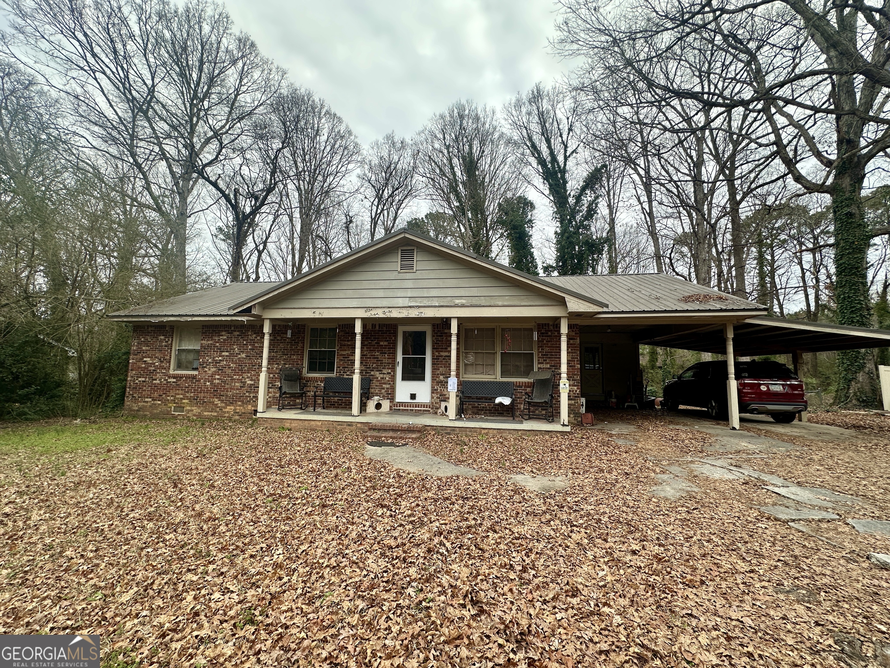 Welcome to 1263 Highway 16 East, Jackson, Butts County, Georgia. This charming brick-faced home features 3 bedrooms and 1 bathroom, offering over 1,400 square feet of comfortable living space. Exterior highlights include a durable metal roof, a classic rocking chair front porch, a carport, and a parking pad. Situated on a spacious 0.65-acre lot, the property provides ample room for gardening, outdoor activities, or even keeping chickens. Currently leased on a month-to-month basis. Please do not trespass or disturb the tenants. For more information, contact the listing agent.