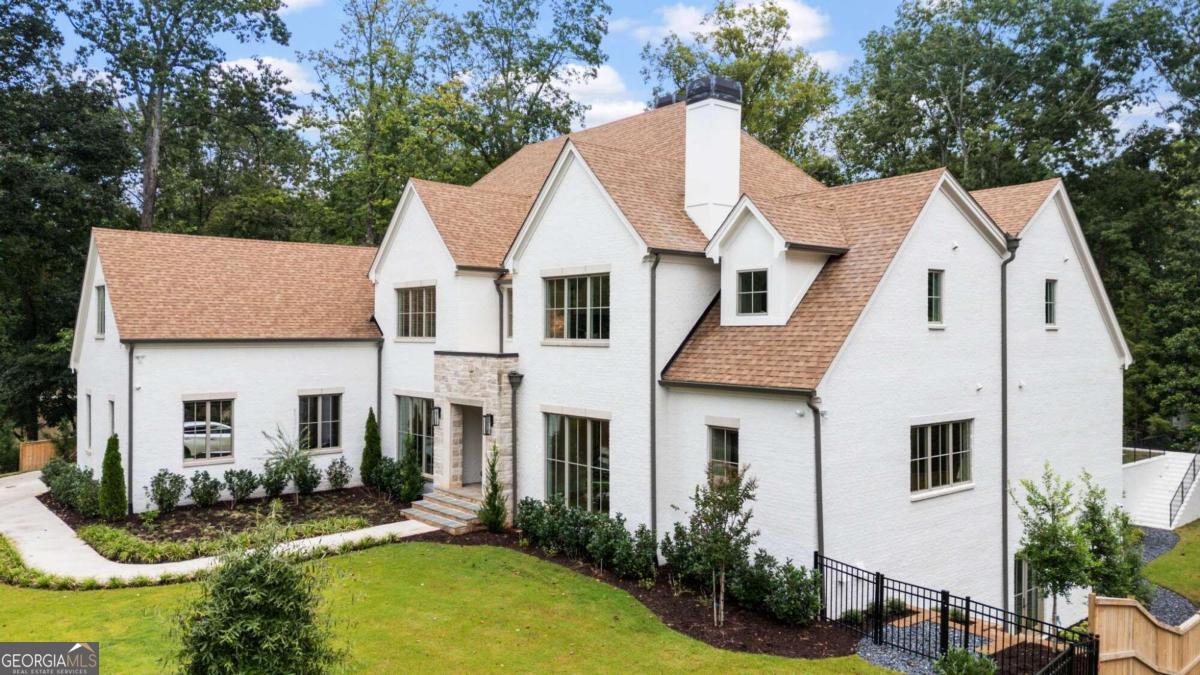 Presenting a stunning 6-bedroom, 6.5-bath estate that spans a remarkable 9,854 square feet, epitomizing opulent living, meticulously designed by 37th Burleigh. Upon entry, you are greeted by grand, soaring ceilings that usher you into an elegantly designed open-concept living area bathed in natural light. At the heart of this residence is a gourmet kitchen, showcasing premium Wolf appliances and a Sub-Zero refrigerator-an ideal setting for the discerning chef. The main-level owner's suite offers unrivaled comfort with its spa-inspired ensuite, adorned with luxurious finishes and custom-built his-and-her closets. The impressive 20 foot ceilings enhance the sense of openness and tranquility. Step outside to a serene private retreat, featuring a walkout pool surrounded by lush, meticulously landscaped grounds-perfect for both relaxation and sophisticated gatherings. Upstairs, discover four generously sized bedrooms, each featuring its own private ensuite, ensuring both comfort and privacy for family and guests. The home's architectural splendor is evident in its beautifully crafted arches and detailed fluted elements, reflecting exceptional craftsmanship throughout. The lower ancillary level reveals a climate-controlled wine cellar, a state-of-the-art home gym, a cutting-edge theater, a billiards room, and an additional bedroom and bath. A Control 4 system integrates seamless audio and visual convenience across the home. Located within the esteemed Jackson Elementary district and just minutes from Buckhead's finest shopping and dining, as well as within jogging distance of Chastain Park, this residence represents the pinnacle of luxurious living. Schedule your private tour today and experience this unparalleled opportunity for yourself.
