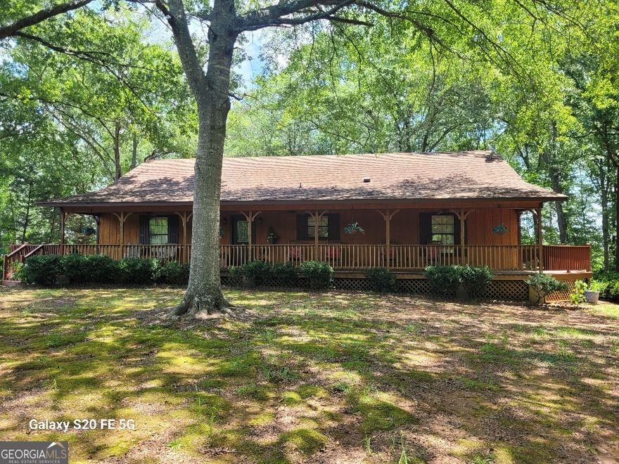 Country living at its best!  This spacious rustic home features an open floor plan kitchen/living/dining room.  Plenty of cabinet space in the kitchen with an island and breakfast bar area.  Beautiful rock fireplace with gas logs in the living room will keep the whole area cozy in the cold weather.  Split bedroom plan with oversized bedrooms and attached bathrooms.  The master bathroom features a large garden tub and separate shower.  Both bedrooms have huge closets, one big enough for an extra bed.  Outside enjoy the wrap around deck with views of West Point Lake.  In the spring the yard is full of azaleas blooming, a sight to behold.  There is also a detached 2 car garage with loft space above that can be finished and used as a man cave or extra storage, a RV shed and a shed with power.  Home has been well maintained and has insulated interior walls to muffle sound and an insulated blanket in the attic which keeps utility bills to a minimum year around.   Home is connected to public water but well is still active to water your garden or other outside uses.  Located near Evansville Access on West Point Lake this is a fisherman's paradise!  Don't miss your opportunity to own this beautiful home, call today to schedule your appointment.