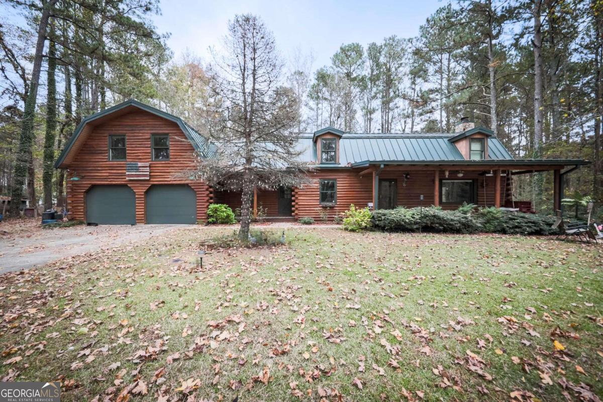 Beautiful, authentic log cabin sitting on 2 spacious acres in Harrison High School District! Huge master bedroom! Interesting architecture with exposed beams throughout. Cleared land ready for various uses from planting to animals. Great schools! Nearby shopping and restaurants!