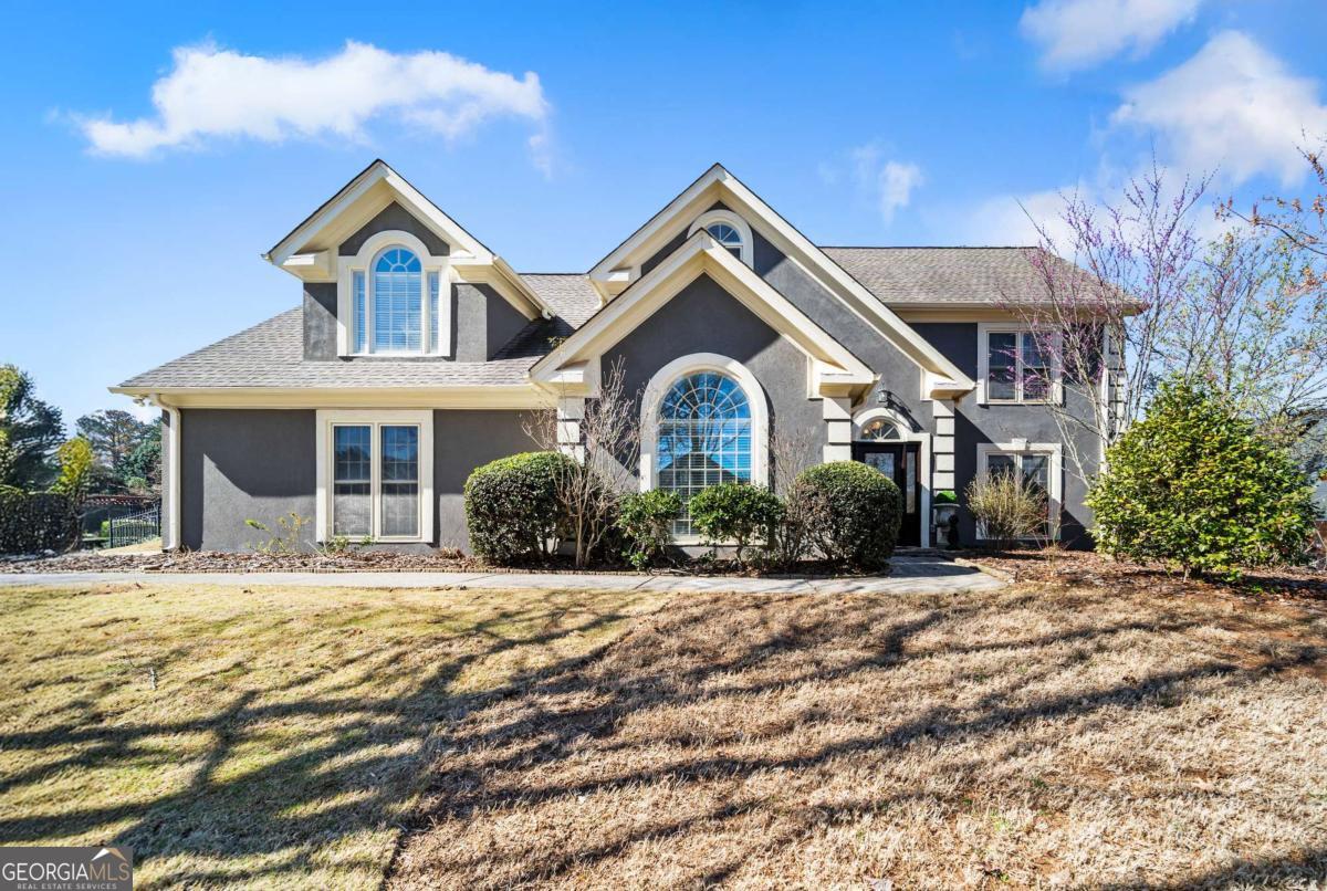 Nestled in the highly coveted Walton High School district of East Cobb, this meticulously upgraded home is brimming with features that truly set it apart. It boasts a brand-new roof, gutters, a freshly painted exterior AND interior, epoxy painted garage, double-paned windows, new garage door system equipped with wi-fi access, and beautifully manicured landscaping. The backyard transforms into a private oasis with custom outdoor lighting, a soothing waterfall, Koi pond, a trellis arch, and a pergola with charming caf lights. Inside, the grand two-story foyer is adorned with an elegant chandelier imported from Germany. The kitchen, recently renovated with high-end appliances, is illuminated by an exquisite Italian chandelier that mirrors the one in the dining room. Upstairs, youCOll find four bedrooms, including a luxurious primary suite with a sitting area and vaulted ceilings. The bathrooms have been updated, and new hardwood flooring has been installed throughout the upper level. This home is located in an active swim/ ALTA tennis community and offers easy access to shopping, dining, major highways, and beautiful nature trails, such as the Chattahoochee National Recreation Area.