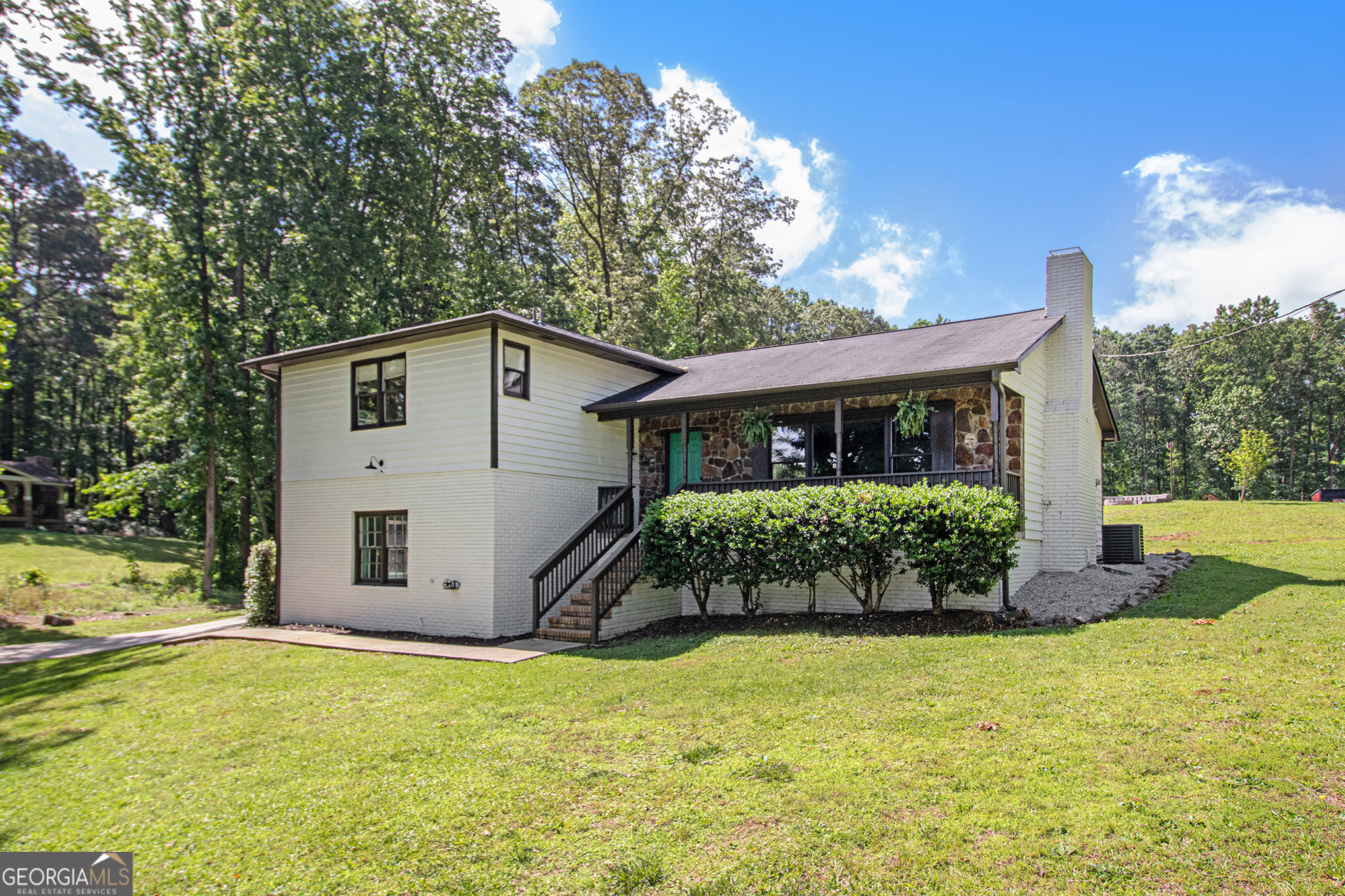 Modern Country Living | Renovated 4BR/3BA Home on 1.5 Acres with Finished Basement Near I-20 Welcome to this fully renovated 4-bedroom, 3-bathroom home offering a rare combination of modern updates, private acreage, and a convenient location just minutes from I-20, Villa Rica, and local shopping and dining. Nestled on a quiet 1.5-acre lot, this move-in ready property delivers style, space, and functionality inside and out. Inside, you'll find a bright and airy open-concept layout perfect for both relaxed living and entertaining. The family room features a striking wood-beamed ceiling, a cozy fireplace framed by custom built-ins, and large windows that flood the space with natural light. The standout kitchen is thoughtfully designed with bold green shaker cabinets, quartz countertops, stainless steel appliances, a farmhouse sink, custom wood vent hood, open shelving, and an oversized island with bar seating and extra storage. Just down the hall, three spacious bedrooms include a serene primary suite with a spa-like bath-complete with subway tile, dual rainfall shower heads, a vessel sink, and modern fixtures. A second full bathroom offers updated lighting, stylish finishes, and a designer mirror. The finished daylight basement adds 902 square feet of flexible living space, including a fourth bedroom, full bath, large bonus room, storage, and rustic touches like shiplap walls and a corrugated metal ceiling-perfect for a home theater, office, gym, or guest space. Outside, unwind in your backyard oasis surrounded by mature trees, fruit trees, grapevines, and a dedicated garden area. A custom fire pit and matching storage shed (white with black trim) complete the retreat. If you're searching for a stylish, turn-key home with character, privacy, and proximity to major conveniences-this one is a must-see. Contact us today to schedule your private tour!