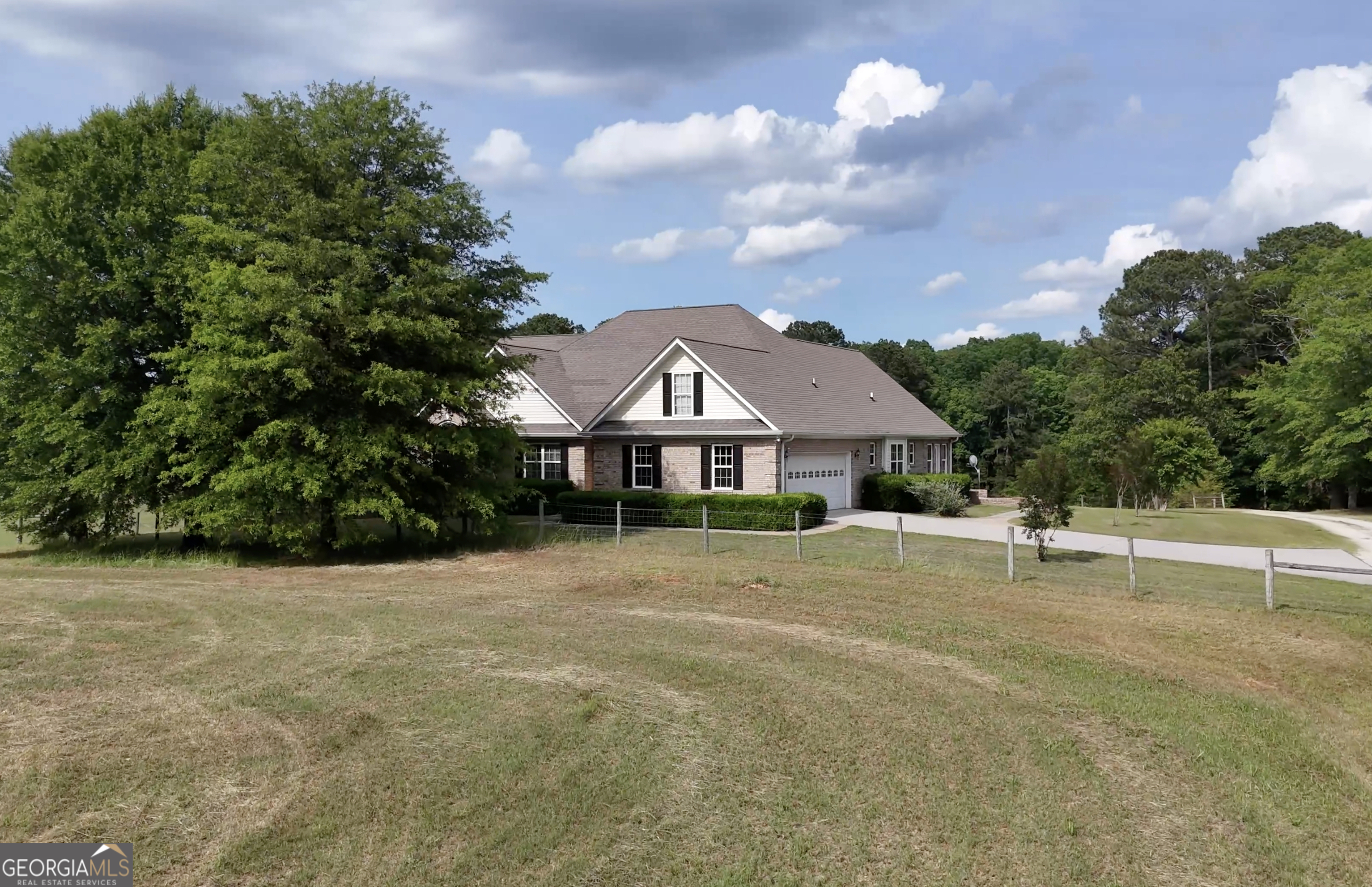 SIGNIFICANT PRICE IMPROVEMENT. Welcome to this charming 5 bedroom home nestled in the heart 36 acres in Walton County! This home is move-in ready, featuring a cozy, eat-in kitchen, a comfortable living room with masonry fireplace, a bright sunroom overlooking the back yard, owner's suite on main level, beautiful hardwood floors, and a full basement with it's own kithchen and entry. This property is located on Hwy 11, making it convenient to both Monroe and Social Circle, but still offering complete privacy. The property features a guest cottage, overlooking a quaint and peaceful pond, and an expansive barn with ample storage room. There is ample double road frontage to allow splitting mini estates for future custom homes.