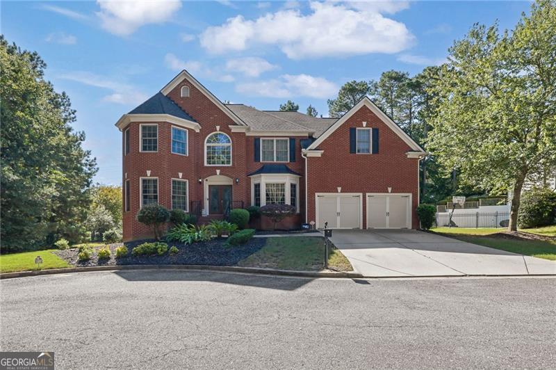 Hamilton Mill's dream community offers an unparalleled lifestyle with an array of resort-inspired amenities, including a top-tier golf course, two exclusive community areas, tennis courts, 6 pickleball courts, basketball and sand volleyball courts, soccer and softball fields, two refreshing pools with a slide and children's play areas, and a fully equipped fitness center. The Hamilton Mill clubhouse is also available for special events, ensuring exciting activities for all ages. The home itself is a spacious 5-bedroom, 4-bathroom residence located in a private cul-de-sac on a rare, oversized lot, providing unmatched privacy. Upon entering, you'll find a grand two-story foyer and wide hallway. To one side, there's a spacious office or formal living room, and on the other, a large dining room with a tray ceiling. The high-ceiling family room is perfect for gatherings. The kitchen is well-appointed with a large island offering additional cabinets, tall stained cabinets, granite countertops, and stainless-steel appliances, while the breakfast area provides an amazing view of the outdoor space. The main level includes a private guest en-suite. Upstairs, the owner's suite is a sanctuary of luxury with a double-tray ceiling and a cozy sitting room. The master bath features his and hers vanities, a garden tub, a separate shower, vaulted ceilings, and an expansive walk-in closet. Three additional well-appointed bedrooms complete this level. The home also offers 1,526 sq. ft. of unfinished living space for additional storage or future expansion. This home is a rare gem offering unparalleled luxury and comfort, ready to welcome you to a life of grandeur and elegance. Its location provides quick access to I-85, making Atlanta and its international airport just a short drive away. You'll also enjoy easy access to entertainment, shopping, and dining options in the Mall of Georgia area, just a 15-minute drive. Please let me know if you are interested in learning more about this extraordinary opportunity or would like to schedule a viewin