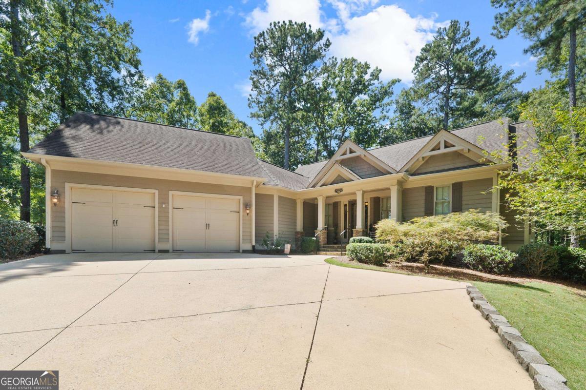 Experience refined lake access living at 1011 Plantation Point Drive with abundant privacy in the prestigious Reynolds Lake Oconee community. This exceptional residence blends timeless architecture with elevated design, offering effortless access to Lake Oconee. A shared set of docks with a large grassy area provides the perfect setting for boating, fishing, or simply enjoying serene sunset moments on the water. Inside, the home showcases generous living and entertaining spaces, curated with high-end finishes and thoughtful details that capture both elegance and comfort. Large windows provide natural lighting, while inviting outdoor areas encourage seamless indoor-outdoor living. Beyond the property, residents enjoy access to Reynolds' world-class amenities-including championship golf courses, fine dining, wellness and fitness facilities, and a vibrant social calendar-making this more than a home, but a destination for luxury and lifestyle.