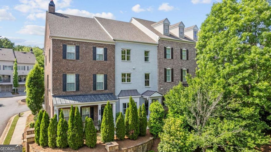 Encore Walk offers executive townhomes in Alpharetta in a community of just 38 homes. The property provides convenient access to Alpharetta's greatest amenities such as the Big Creek Greenway, the Alpha Loop, Ameris Amphitheater, Top Golf, Avalon, downtown Alpharetta and the North Point Corridor. The Fulton County Science Academy is less than half a mile away and the #1 Ranked Private School in the State of Georgia in 2025 according to Niche.com. There are also amazing public schools including Milton High, Northwestern Middle & Manning Oaks Elementary.  As you enter your new home, you will enjoy the private main floor entry that features a bedroom and full bath, currently used as an office. The main floor features an open floor plan with 10-foot ceilings on the main level, upgraded hardwood floors, 42C White Cabinetry with light Quartz countertops, subway backsplash, Stainless Steel Gas Range with built-in microwave, dishwasher and matching French Door Stainless Steel Refrigerator. This floor plan features the largest island in the community with plenty of room for 4 stools, an open dining area and a beautiful Great Room with a Gas Fireplace and slate surround. The covered deck area spans the entire length of the home and is the perfect outdoor retreat. Upstairs you will enjoy two secondary bedrooms, a hall bath and the convenience of an upstairs laundry room with the washer and dryer included. The ownerCOs suite is ideal with plenty of space for a sitting area or desk area. The ownerCOs shower is very spacious, stunning floor tile, wall tile and large bench area. You cannot beat this incredible location combined with these amazing features and spacious floor plan. The home has been freshly painted. This property provides the best location and easy access to all the amenities you could want. Welcome home!