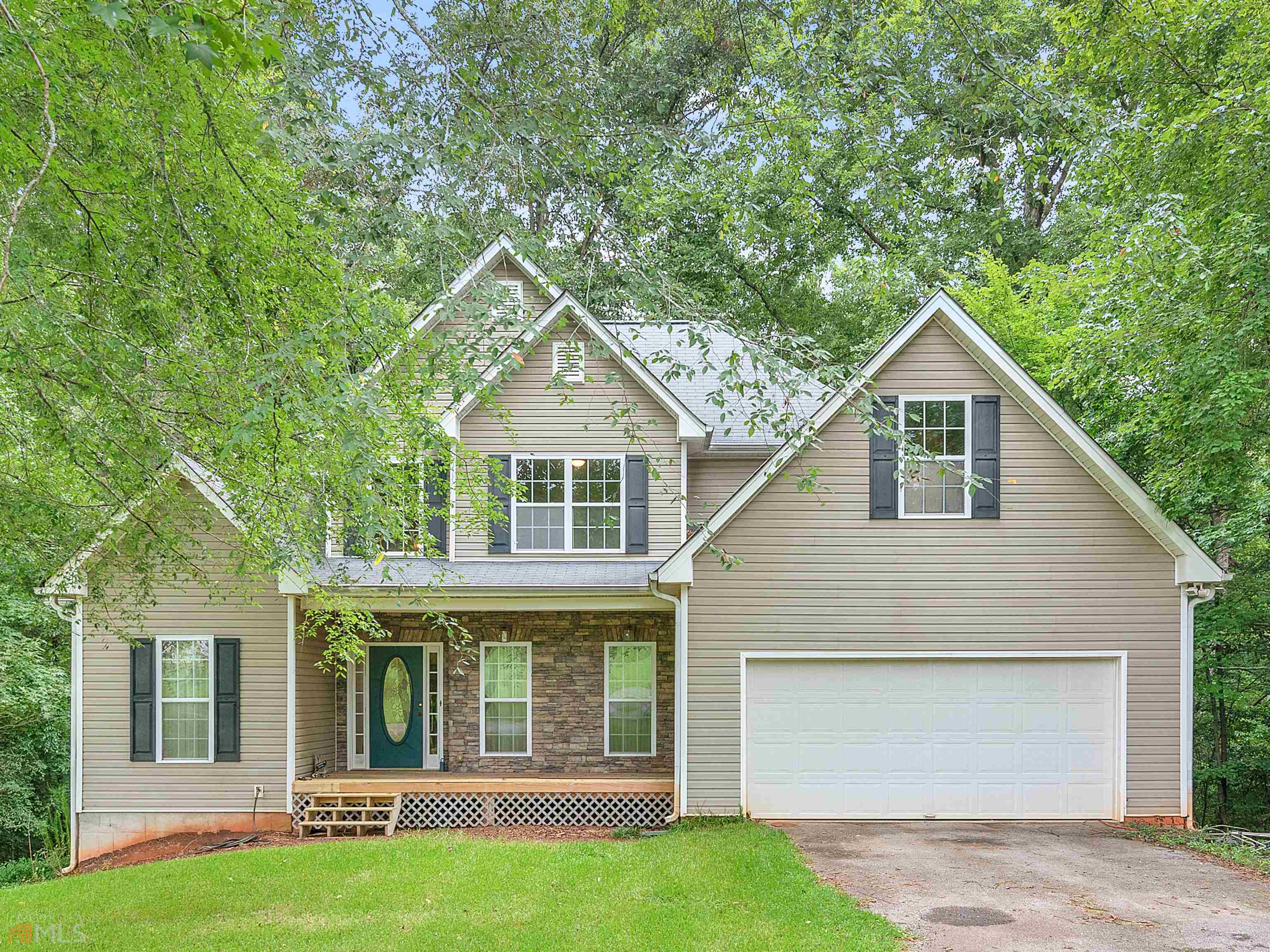 Spacious, 4 bedroom, 2 full and 2 half baths on a private, 3 acre lot in Conyers. Walk in to see a 2-story foyer with beautiful hardwood floors and formal dining room. Vaulted family room features a stacked stone fireplace. Kitchen includes a pantry, breakfast bar, and breakfast area. Primary suite boasts a double trey ceiling, walk-in closet, double vanity, garden tub, and separate shower. Unfinished basement offers tons of options to expand your living space or use for extra storage. Relax and enjoy your morning coffee or evening beverage from the covered front porch or large back deck. Ask how you can receive up to $1500 credit by using one of our preferred lenders. Exclusions may apply.