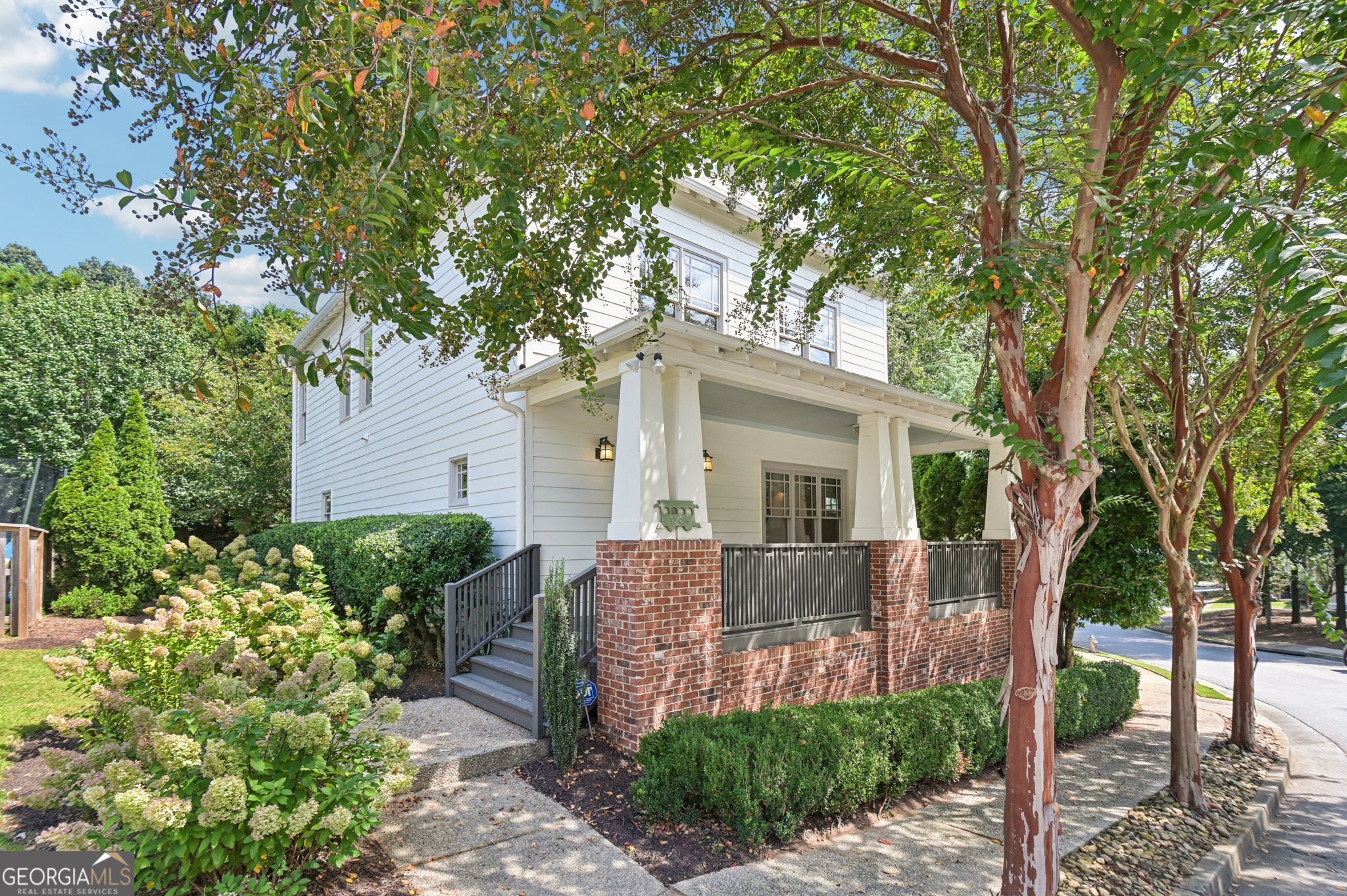 Energy-Efficient Craftsman in Prime Intown Location! Welcome to East Village Park-where timeless charm meets modern efficiency. This certified EarthCraft Craftsman-style home offers 3 bedrooms, 2.5 bathrooms, and 2,068 sq ft of beautifully designed living space in a community known for its sidewalks, streetlights, and friendly HOA. Enjoy peaceful mornings on the covered rocking chair front porch, then step inside to discover refinished hardwood floors, fresh interior paint, and a layout that blends comfort and function. A separate dining room provides the perfect space for hosting, while the sunny eat-in kitchen features granite countertops, a gas range, stainless steel appliances, and easy access to the rear deck-ideal for grilling or unwinding. The inviting family room centers around a gas fireplace, creating a cozy atmosphere year-round. Upstairs, the oversized primary suite includes a tray ceiling, private balcony, dual vanities, a garden tub, and a spacious walk-in closet. Two secondary bedrooms and a full bath complete the upper level. Tucked alongside neighborhood green space with a natural privacy buffer, this home provides serenity just minutes from the best of Atlanta-Zoo Atlanta, Grant Park, the Beltline Southside Trail, East Atlanta Village, and some of the city's most popular parks, restaurants, and breweries. This energy-efficient gem combines location, livability, and low-maintenance lifestyle. Don't miss it!