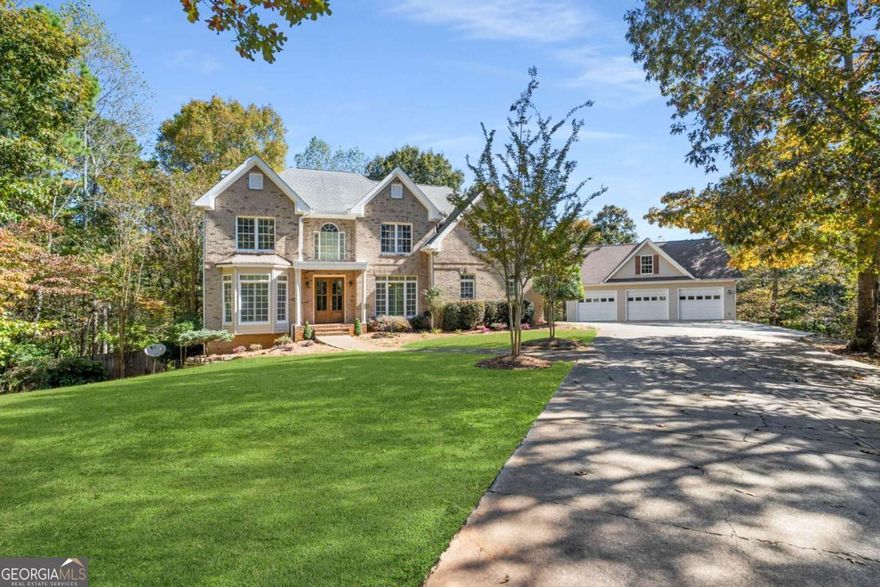 Situated amongst rolling hills and acres of colorful Fall foliage is this beautiful, four-sided brick estate on nearly 11 acres. Meander through the gated entry and down the private, tree-lined driveway until you arrive at this stately homestead. Walk through the new double oak doors and you're greeted by soaring ceilings, a freshly painted interior, gleaming hardwood floors and large spaces. The entry is flanked by a spacious home office or formal living room to your left and formal dining room to your right. The heart of the home is just ahead - an open-concept fireside family room, breakfast area and large kitchen. The kitchen features 42" white cabinetry, granite countertops, stainless steel appliances, a butcher block center island and a spacious walk-in pantry. This level is completed by a convenient powder room and two-car garage with high-end epoxy floor coating. Retreat upstairs to the bedrooms where you'll find a spacious master suite, three generously-sized guest bedrooms (all with new carpet and paint), a large shared bath with multiple sinks and a convenient upstairs laundry room. The master suite is the perfect spot for relaxation highlighted by a double tray ceiling, large sitting area, dual walk-in closets, hardwood floors, a private rear covered porch and a spacious ensuite bathroom. The bathroom features dual vanities, a large whirlpool tub, a walk-in shower and a separate toilet closet. You'll love entertaining in the finished basement. With tons of square footage to create your ideal layout, there's a large living area, a bedroom, a full bath, two additional rooms (that would be perfect for a game room and a home gym) as well as an ample storage closet. One of the crown jewels of this property is the detached three-car garage with a huge unfinished bonus space above. Create the perfect man cave, home office, hang-out space, or whatever your heart desires. The property is nearly 11 acres and, with no HOA, you have the ability to create your own oasis. Chickens? Sure! Hunting? Why not! Car collector? No problem! A tankless hot water heater, recently serviced septic system, newer HVAC's and well with saltwater softening system and filter are added bonuses. Conveniently located just 6 minutes from historic downtown Ball Ground, 20 minutes to Jasper and less than an hour to Blue Ridge or Atlanta, you'll love being away from the hustle and bustle while still having access when you need it.