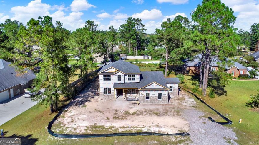 Cypress Lakes is a small, exclusive and secluded Gated Community in South Effingham with Breathtaking Lake Views around every curve. This Tree-Lined Neighborhood was built around a passion for Aviation and offers the integration of an Aviation Lifestyle with Modern Luxuries and a strong sense of Community. Your Beautiful, New Brick Home sits on a Large .61 Acre Lot with Front & Back Views of the Lakes and will feature Wedding Flair Steps, an inviting Front Porch, 2-Car Garage and an additional space for the Golf Cart or Storage. Enter through your Wood Stained Front Door to a timeless and welcoming Foyer Entrance with Board & Batten Walls and Shaker Style Wainscotting in Dining Room. Your New Kitchen will feature a large Island, Pendant Lighting, Quartz Countertops, Thor SS Appliances & 42" Cabinetry. The Primary Suite is located on Main Floor with en suite Glass Shower, Soaking Tub, Double Vanities and large Walk-In Closet. Upstairs is the nice Loft Area, 3 Additional Bedrooms and Walk-In Closets.  This Location enjoys the desirable South Effingham Schools!