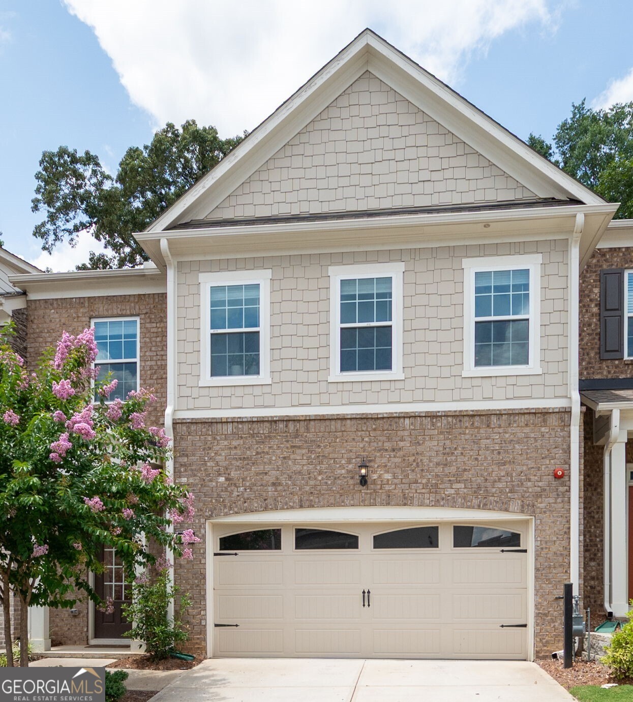 Stunning Upgraded Townhome in Sought-After Community Minutes from Downtown Woodstock! Welcome to this meticulously maintained 3-bedroom, 3.5-bath townhome, perfectly located just minutes from the vibrant heart of downtown Woodstock. Situated in a highly desirable neighborhood with fantastic amenities including a sparkling pool and pool house, this home offers the best of comfort, convenience, and style. Step inside to an the open-concept layout that seamlessly connects the gourmet kitchen to the expansive great room, creating the perfect space for entertaining or relaxing in style. Enjoy a spacious dining room ideal for hosting gatherings, all enhanced by abundant natural light and upscale finishes throughout. Enjoy gorgeous hardwood flooring on every level, an inviting shiplap-accented entryway, and a beautiful brick fireplace with mantle-ideal for cozy evenings. The gourmet kitchen is a chef's dream, featuring upgraded white cabinetry and hardware including under cabinet lighting, spacious kitchen island with top-level granite countertops, cafeteria style backsplash, direct vent hood, and stainless steel appliances. Retreat to the spacious primary suite with its own private balcony and a luxurious en-suite bath showcasing an extended walk-in shower with high-end designer tile and soaking tub. Boasting spacious secondary bedrooms, each complete with its own private en-suite bathroom and generous walk-in closet, each bathroom is tastefully appointed with premium finishes, upgraded cabinetry and shower tile work to the ceiling. The private, fenced backyard offers a peaceful outdoor space perfect for relaxing or entertaining. This home truly has it all-location, luxury, and low-maintenance living. This stunning townhome boasts over $60,000 in upgrades - a full list of enhancements is included in an attachment. So don't miss your opportunity to own, live, and enjoy being in one of Woodstock's most desirable communities !!!