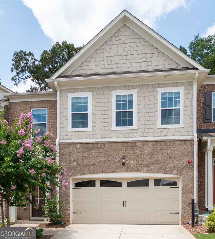 Stunning Upgraded Townhome in Sought-After Community Minutes from Downtown Woodstock! Welcome to this meticulously maintained 3-bedroom, 3.5-bath townhome, perfectly located just minutes from the vibrant heart of downtown Woodstock. Situated in a highly desirable neighborhood with fantastic amenities including a sparkling pool and pool house, this home offers the best of comfort, convenience, and style. Step inside to an the open-concept layout that seamlessly connects the gourmet kitchen to the expansive great room, creating the perfect space for entertaining or relaxing in style. Enjoy a spacious dining room ideal for hosting gatherings, all enhanced by abundant natural light and upscale finishes throughout. Enjoy gorgeous hardwood flooring on every level, an inviting shiplap-accented entryway, and a beautiful brick fireplace with mantle-ideal for cozy evenings. The gourmet kitchen is a chef's dream, featuring upgraded white cabinetry and hardware including under cabinet lighting, spacious kitchen island with top-level granite countertops, cafeteria style backsplash, direct vent hood, and stainless steel appliances. Retreat to the spacious primary suite with its own private balcony and a luxurious en-suite bath showcasing an extended walk-in shower with high-end designer tile and soaking tub. Boasting spacious secondary bedrooms, each complete with its own private en-suite bathroom and generous walk-in closet, each bathroom is tastefully appointed with premium finishes, upgraded cabinetry and shower tile work to the ceiling. The private, fenced backyard offers a peaceful outdoor space perfect for relaxing or entertaining. This home truly has it all-location, luxury, and low-maintenance living. This stunning townhome boasts over $60,000 in upgrades - a full list of enhancements is included in an attachment. So don't miss your opportunity to own, live, and enjoy being  in one of Woodstock's most desirable communities !!!