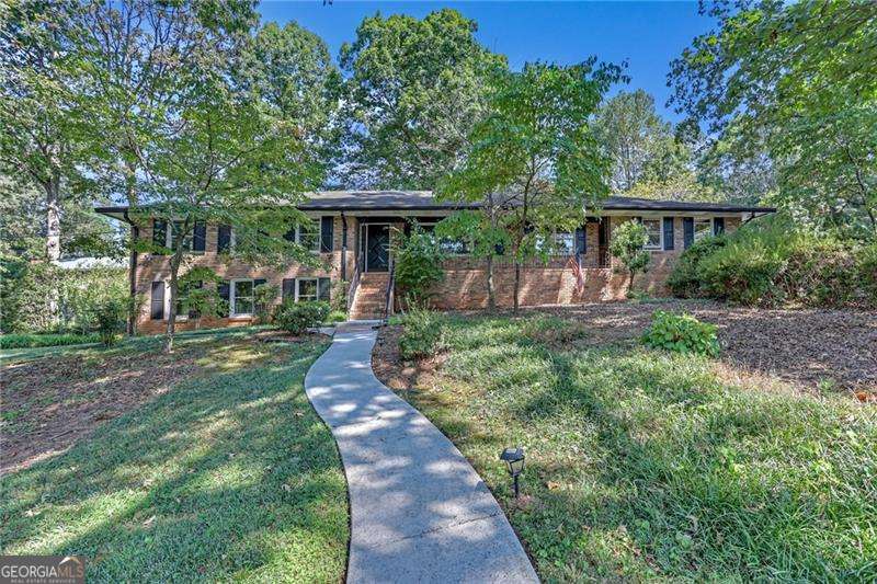 First time on the market from the ORIGINAL OWNERS! This well-maintained 4BR, 2BA all-brick ranch sits proudly on a desirable corner lot in East Cobb, offering timeless curb appeal and a solid foundation. Relax on your front porch and wave at neighbors as they walk by. Inside, you'll find a spacious layout with natural light throughout, generous living areas, and a full basement providing endless possibilities. The property also includes a greenhouse for garden enthusiasts and outdoor shed for extra storage. Mature landscaping surrounds the home, enhancing privacy and creating a serene setting. NO HOA or rental restrictions-perfect for investors or future homeowners seeking flexibility. With its unbeatable location near top-rated schools, shopping, dining, and parks, this rare find is ready to be personalized into your dream home.