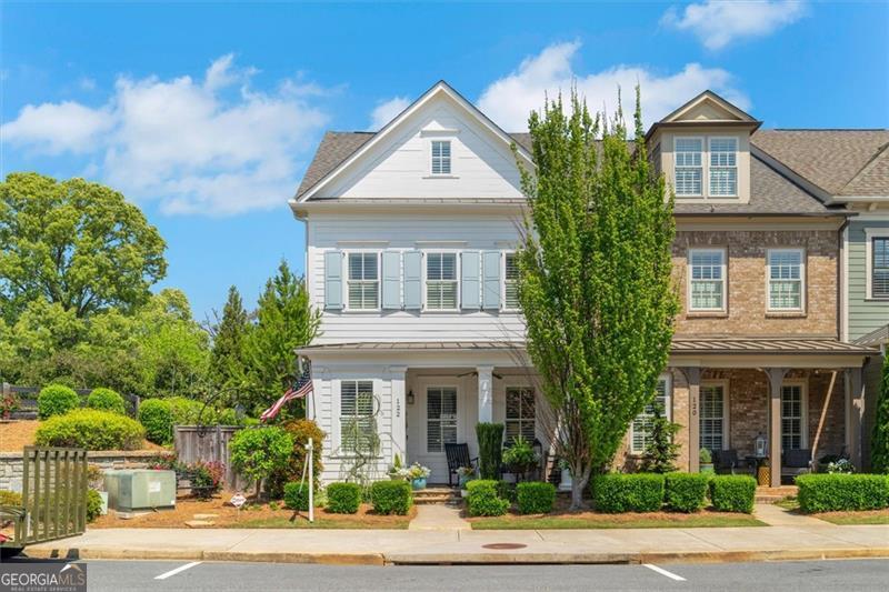 This exceptional end-unit, 3-story townhome, located in the highly sought-after South on Main community, offers the perfect blend of luxury and convenience, just steps from vibrant Downtown Woodstock. Featuring main-level living with soaring 10-foot ceilings and an abundance of natural light, this home is elegantly appointed with custom upgrades, including plantation shutters, lofted beams, and crown molding throughout. The chefCOs kitchen is a true highlight, equipped with stainless steel appliances, a professional chefCOs range, marble island, soapstone countertops, 15C deep shaker soft-close cabinets, and a spacious walk-in pantry. Step outside from the main floor to a private side yard, complete with manicured gardens and two patio spacesCoideal for outdoor entertaining. The home also boasts a detached garage with gated rear-entry and a fully finished, climate-controlled room above, perfect for a home office, game room, or entertainment space. The second floor includes a guest bedroom and a luxurious owner's suite with custom closet systems. The third floor features two additional bedrooms and a large common area. The home is elevator-ready with electrical already installed and comes equipped with a security system for added peace of mind. DonCOt miss your chance to live in the heart of Woodstock, just steps away from the community fitness center, pool, and clubhouse. Your dream home awaits!