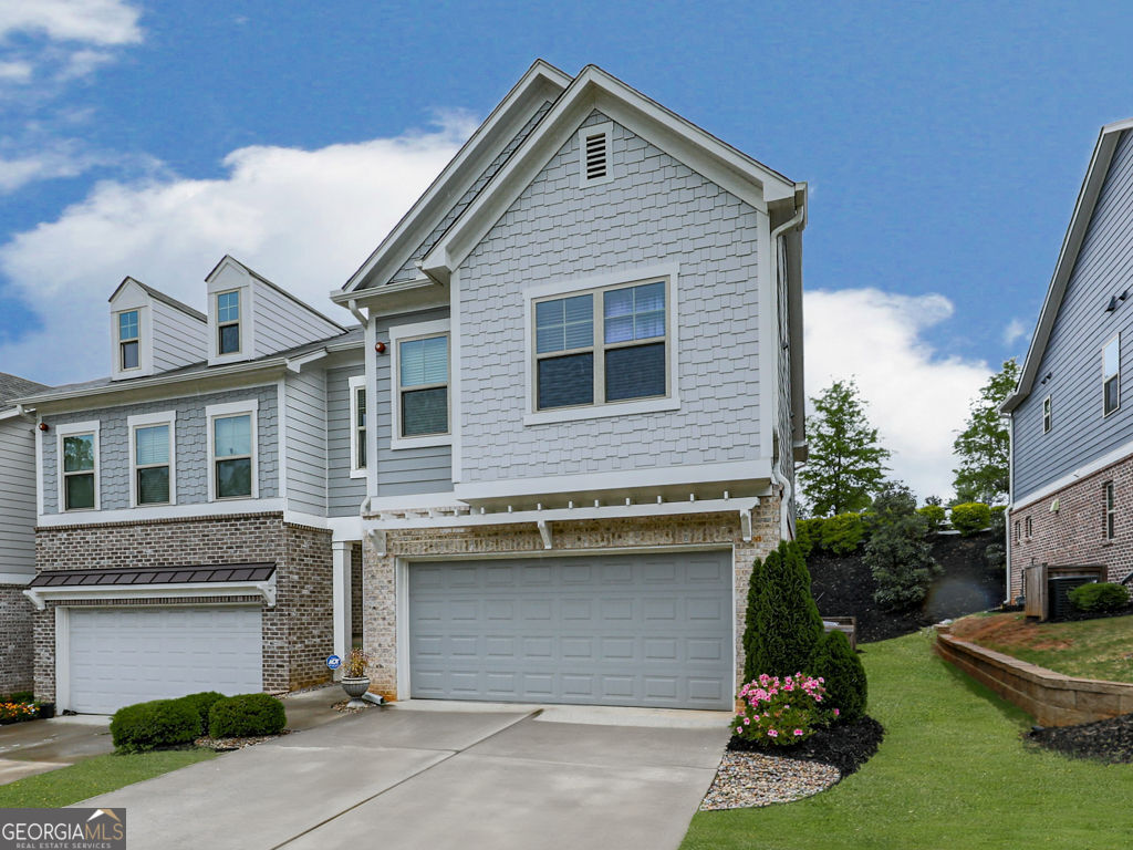 Welcome to 130 Maple Creek Way, Woodstock, GA 30188-a rare END unit townhome that perfectly blends sophistication and comfort. Upon entering, you'll be greeted by an elegant designer color scheme and meticulous attention to detail, creating a warm and inviting ambiance that feels like home. This well-cared-for END unit showcases a calming color palette and features a modern island kitchen equipped with a walk-in pantry and quartz countertops, which seamlessly connects to a spacious great room, ideal for entertaining guests. Furnishing are available for sale, making this a seamless turn-key opportunity. The main level is adorned with upgraded luxury vinyl flooring, enhancing both style and durability. The master suite serves as a private retreat, complete with a comfortable sitting area and a beautifully designed master bath. Generously sized secondary bedrooms offer plenty of room for family or visitors. The exceptional backyard is a stunning oasis of its own, featuring extensive landscaping that showcases nature's beauty. Enjoy plenty of parking with a 2-car garage and a long driveway that accommodates additional vehicles. Located mere minutes from downtown Woodstock, with easy access to highways and proximity to shopping, recreation, and dining, this townhome masterfully combines convenience and charm, making it the perfect place to call home.