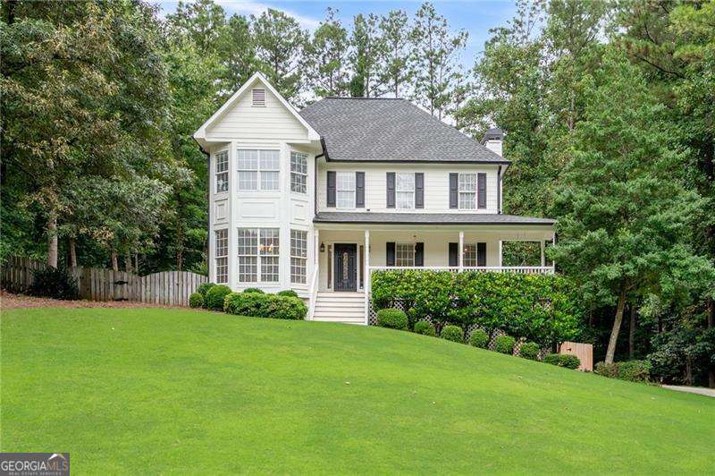 Welcome to 435 Cambrley Lane-a beautifully updated home combining charm, space, and high-end finishes throughout. Enjoy the inviting rocking chair front porch with new lighting and a classic porch swing. Inside, you'll find ALL NEW flooring: hardwoods on the main level and plush carpet in the bedrooms. The main level features a fully renovated kitchen with new cabinetry, appliances, farmhouse sink, lighting, plumbing fixtures, and modern hardware. Adjacent is a bright family room with a stunning stone fireplace and gas logs, plus a spacious dining room with crown molding that seats 12+. The owner's suite has been completely updated, boasting a spa-style bath with double vanity, soaking tub with floor-mounted faucet, walk-in shower, and a walk-in closet with built-in vanity. The secondary bedrooms share a beautifully renovated bath with new flooring, vanity, and fixtures. Downstairs, basement includes a large rec room with a bar and built-in shelving-ideal for entertaining or relaxing. Situated on an almost 3/4-acre lot with a flat driveway, oversized fenced backyard, custom outbuilding, and a screened-in porch off the kitchen that provides a peaceful outdoor retreat. This home blends modern upgrades with timeless character-don't miss your chance to see it! From the moment you arrive, this beautifully upgraded home makes a lasting impression. Close to Schools, Shopping and Dining.