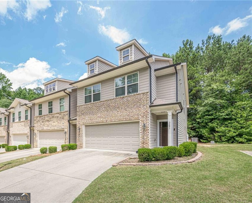Welcome to 3291 Wild Basil Lane. A Stylish and Spacious end unit Condo in the Heart of Buford! Step into an open-concept floor plan enhanced by custom trim throughout, adding charm and architectural detail. As you enter, you're greeted by an entrance foyer that leads to a bright, open-concept layout featuring a spacious gourmet kitchen, complete with a large island with seating, stone countertops, subway tile backsplash, and stainless steel appliances ideal for entertaining or daily living. Relax in the inviting family room anchored by a stunning stacked stone fireplace, seamlessly flowing into the dining area perfect for hosting friends and family. Upstairs, you'll find a spacious loft perfect for a media room, home office, or play area. The oversized owner's suite includes a walk-in closet and spa-inspired ensuite with double vanities, a soaking tub, and a separate glass-enclosed shower. Two additional bedrooms share a full bath, and a convenient upstairs laundry room adds ease to your daily routine. Enjoy a fenced backyard ideal for pets, play, or private relaxation. Both the front and back doors have been replaced with energy-efficient models, and the back door features built-in blinds for added privacy and functionality. A 2-car attached garage and low-maintenance exterior complete the package. Conveniently located just minutes from the Mall of Georgia, I-85/I-985, parks, shopping, dining, and top-rated schools. This home beautifully blends modern comfort, functional design, and prime Buford location. Ideal for families, professionals, or anyone seeking effortless living. Schedule your showing today.