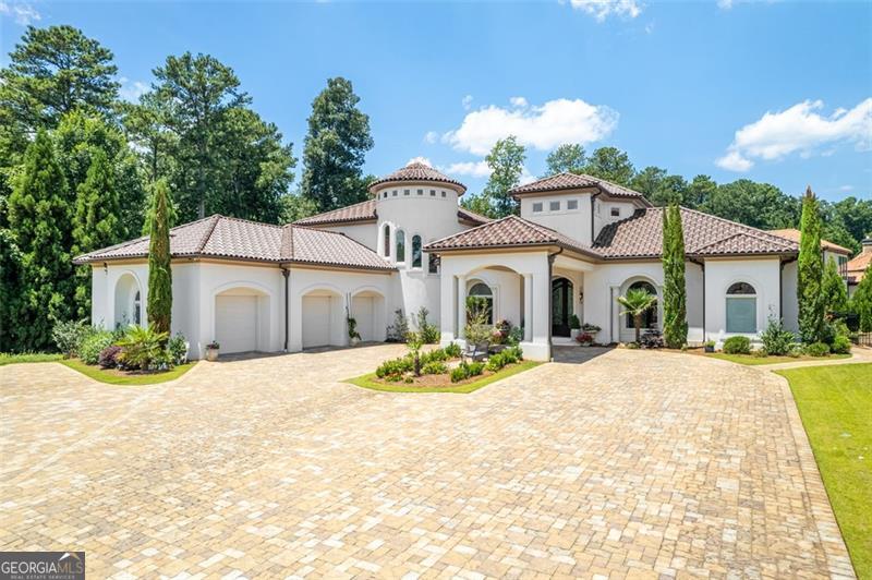 This masterfully designed Mediterranean estate, crafted by its original owner, effortlessly combines timeless elegance with contemporary sophistication and is now being offered for the first time. Set in an exclusive cul-de-sac, you are welcomed through an exquisite grand iron and glass front door leading to an expansive living space adorned with flawless marble floors and striking fireplaces. The open-concept layout flows seamlessly into the resort-inspired backyard, where a captivating pool with limestone decking, meticulously manicured professional landscaping, and an oversized covered balcony create the ideal setting for extravagant entertaining. The chef's kitchen is nothing short of a masterpiece, featuring custom European cabinetry, top-of-the-line integrated appliances, a private scullery, and opulent waterfall-edge countertops. The main level also boasts the serene owner's suite showcasing unparalleled luxury, a refined private office perfect for work or study, and a spacious guest suite with en-suite bath that ensures privacy and comfort. Additional thoughtful touches include a sophisticated office and well-appointed laundry room with custom-built cabinetry. A dramatic curved staircase, framed by an expansive window leads upstairs to three generously sized en-suite bedrooms, including one with a private balcony overlooking the tranquil backyard-each offering a private retreat for family or guests. The lower level features an en-suite bedroom, fully equipped gym (which could easily be converted back to a bedroom), full bathroom, and state-of-the-art home theater. The private elevator services all three levels, and every modern amenity has been meticulously incorporated to elevate your lifestyle. This extraordinary estate presents an unparalleled opportunity to own a flawlessly designed sanctuary where every detail has been thoughtfully curated for the most discerning buyer.