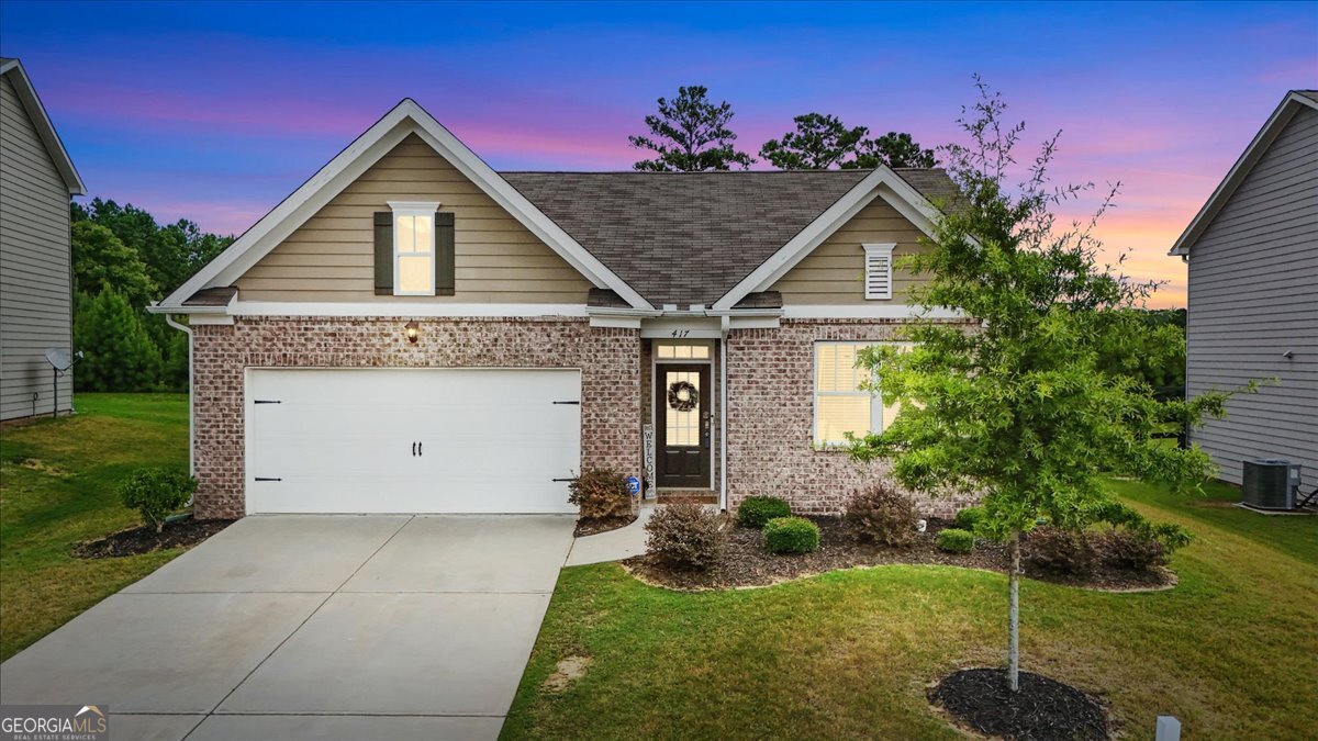 Welcome to this true 4 bedroom, 2 bathroom step-less ranch located in the highly sought after Wild Timber section of the award winning Seven Hills community. Built in 2020, this home offers modern construction, energy efficiency, and a functional open concept layout that caters to both everyday living and entertaining. Situated on a level, fenced lot with private wooded views and no home behind, the outdoor space offers a peaceful and private backdrop for morning coffee, backyard games, or hosting gatherings under the covered rear patio. Inside, the spacious living room features a cozy gas fireplace and abundant natural light. The gourmet kitchen is a standout with granite countertops, a large center island with bar seating, white shaker-style cabinets with crown molding, beveled subway tile backsplash, stainless steel appliances, and a walk-in pantry. The open flow between kitchen, dining, and living areas makes this home perfect for entertaining guests or enjoying time with family. The oversized primary suite is tucked privately at the rear of the home and includes a large walk-in closet, double vanity, separate tiled shower, and a soaking tub. Three additional bedrooms provide flexible options for a home office, playroom, or guest rooms-all on one convenient level. Additional upgrades include smart home technology, recessed lighting, and durable LVP flooring in main living areas. Wild Timber is located in the top-rated North Paulding school district and offers access to Seven Hills' incredible 13-acre amenity complex featuring a resort-style water park, clubhouse, tennis courts, pickleball, basketball courts, playgrounds, walking trails, and more. Enjoy an active lifestyle and close proximity to shopping, dining, schools, and recreational options.