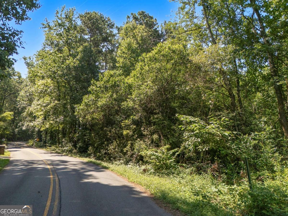 Discover a rare opportunity to create your custom dream home on this buildable 2.3-acre lot, offering a secluded and tranquil setting surrounded by established neighborhoods and upscale homes. Nestled just off Barrett Parkway and only minutes from the natural beauty of Kennesaw Mountain, this prime location combines the serenity of suburban living with unbeatable convenience. Enjoy nearby scenic walking trails, biking paths, and a variety of recreational amenities, as well as easy access to shopping and dining. This peaceful, private property is ready for your vision-an ideal canvas for your personal retreat.