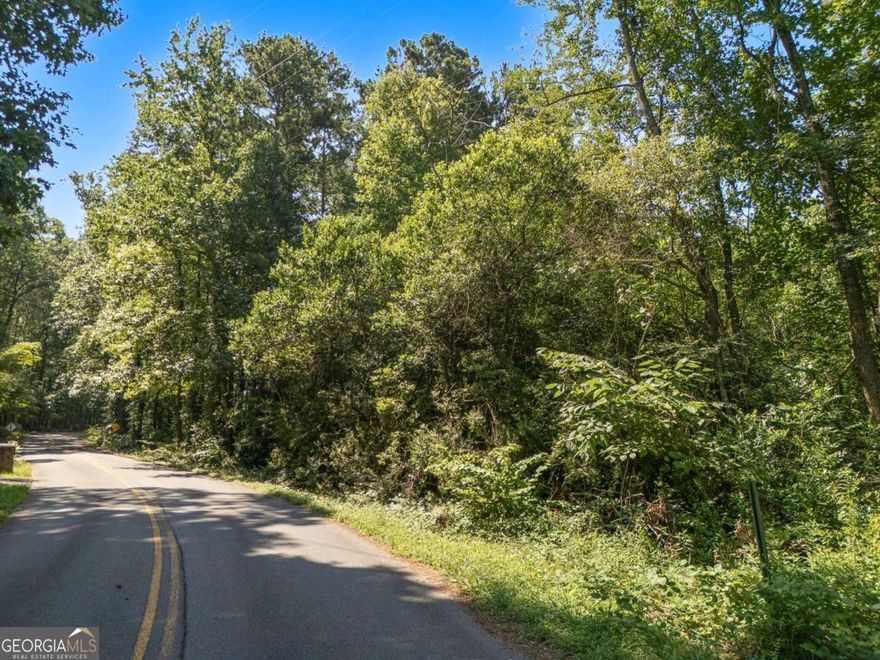 Discover a rare opportunity to create your custom dream home on this buildable 2.3-acre lot, offering a secluded and tranquil setting surrounded by established neighborhoods and upscale homes. Nestled just off Barrett Parkway and only minutes from the natural beauty of Kennesaw Mountain, this prime location combines the serenity of suburban living with unbeatable convenience. Enjoy nearby scenic walking trails, biking paths, and a variety of recreational amenities, as well as easy access to shopping and dining. This peaceful, private property is ready for your vision-an ideal canvas for your personal retreat.