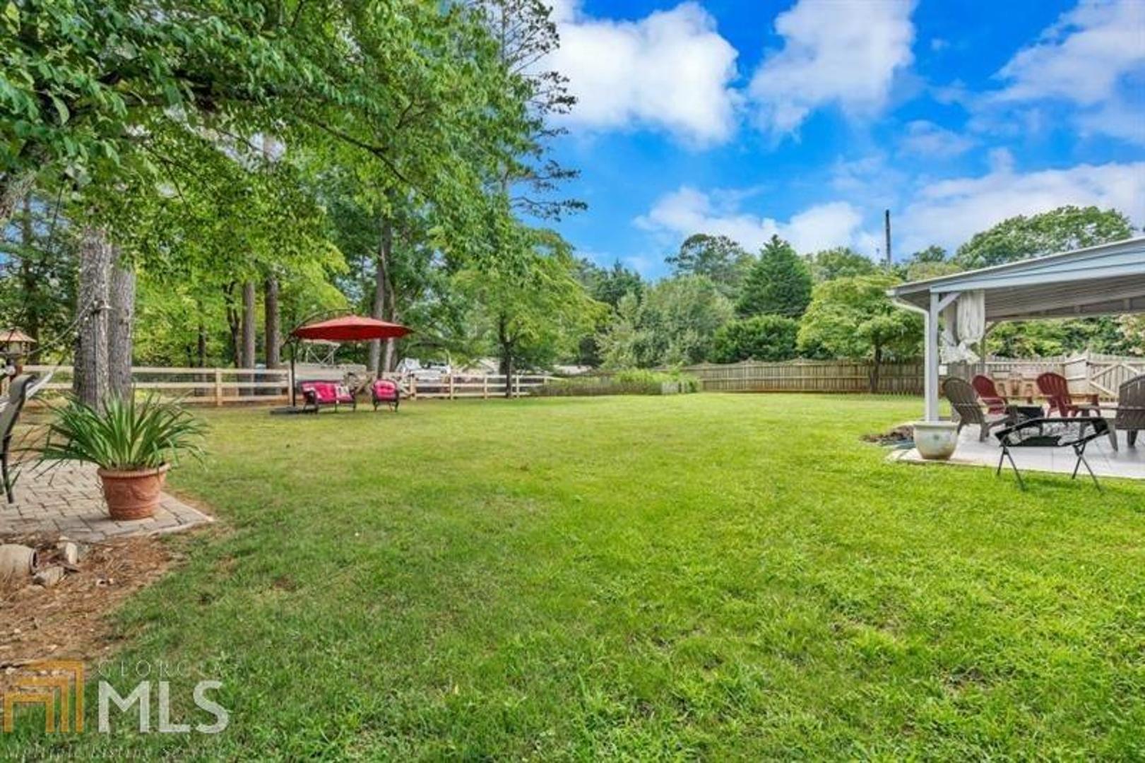 WOW! OPEN & SPACIOUS GORGEOUS Split Level Home with HUGE AMAZING LEVEL & FENCED PRIVATE BACKYARD! Beautifully Renovated for todays lifestyle! Fabulous Kitchen Boasts White Cabinetry, Granite Countertops, Beautiful Backsplash, Upgraded Appliances, Large Island and More that opens to the Family Room and Dining Space. Freshley Painted & Loads of Natural Daylight! Beautiful Flooring and more! Upstairs is the Master Suite plus two Large Secondary Bedrooms Stunning Full Bath! The lower level features a complete inlaw/guest suite. With sleeping area (4th bedroom area), large living space area plus a complete second kitchen and updated full bath! Enjoy the AMAZING fenced backyard with covered patio, a brick patio, a garden, plenty of room to play, and a back area great for RV or Boat storage! No HOA. Great Schools. Low Forsyth County Taxes. Great Location!