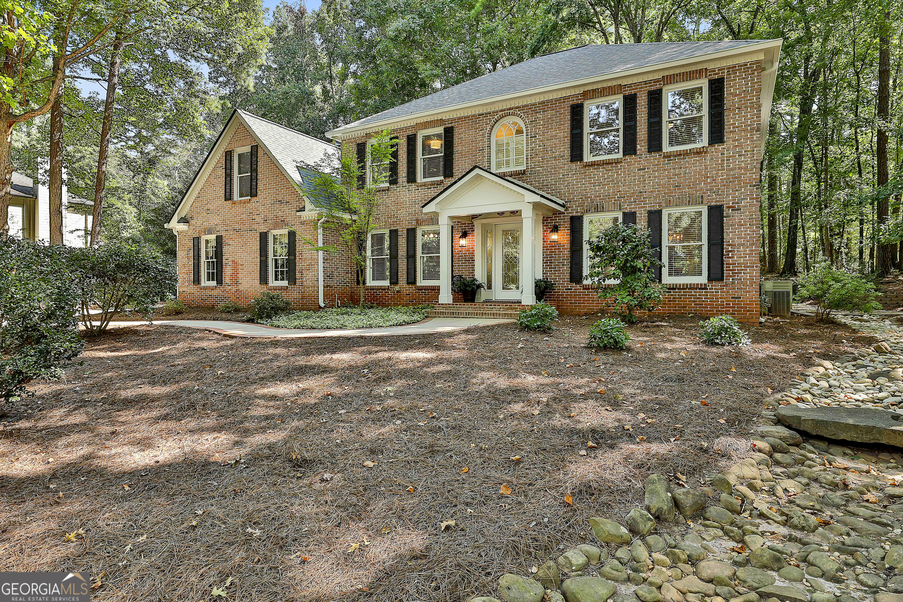 This absolutely beautiful home is ready for you! Located in a prime Peachtree City spot, you can easily walk to Braelinn Golf Club and enjoy a quick golf cart ride to schools, shopping, and more. The main level boasts a spacious formal dining room and a large bar/butler's room equipped with a wine cooler and custom cabinetry. French doors lead to a large screened porch with a vaulted ceiling, creating a perfect space for relaxation. A versatile main-level bedroom, which doubles as a home office, features a Murphy bed enclosed in custom cabinetry, and there's a full bath accessible from both the bedroom and the hallway. The gorgeous family room and sunroom offer lovely views of the landscaped backyard, with a gas log fireplace, built-in bookshelves, and a separate entrance from the driveway. The updated kitchen is a chef's dream, with granite counters, a new microwave, and a breakfast area overlooking the charming brick paver patio. Upstairs, the owner's suite is your place to relax and recharge, complete with a recently updated, spa-like bath featuring custom cabinetry, a walk-in shower, a soaking tub, and a custom walk-in closet. There are two additional spacious bedrooms, both with new lighting, and a beautifully updated full hall bath. The fourth bedroom, which can also serve as a bonus room, has a large walk-in storage closet. Additional updates include fresh Interior and Exterior paint in August 2025 (excluding the owner's suite and bath). Lovingly maintained by the original owner, this home combines thoughtful updates with timeless charm.