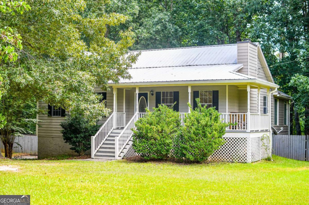 Fantastic, move in ready house with great back yard! 5 minutes to I-20 but with great privacy. Fresh interior paint, newer roof, updated HVAC, basement workshop, sunroom/formal dining, and lots of space to expand in the basement. Wood burning fireplace in den, updated deck, rocking chair covered front porch, and so much more.
