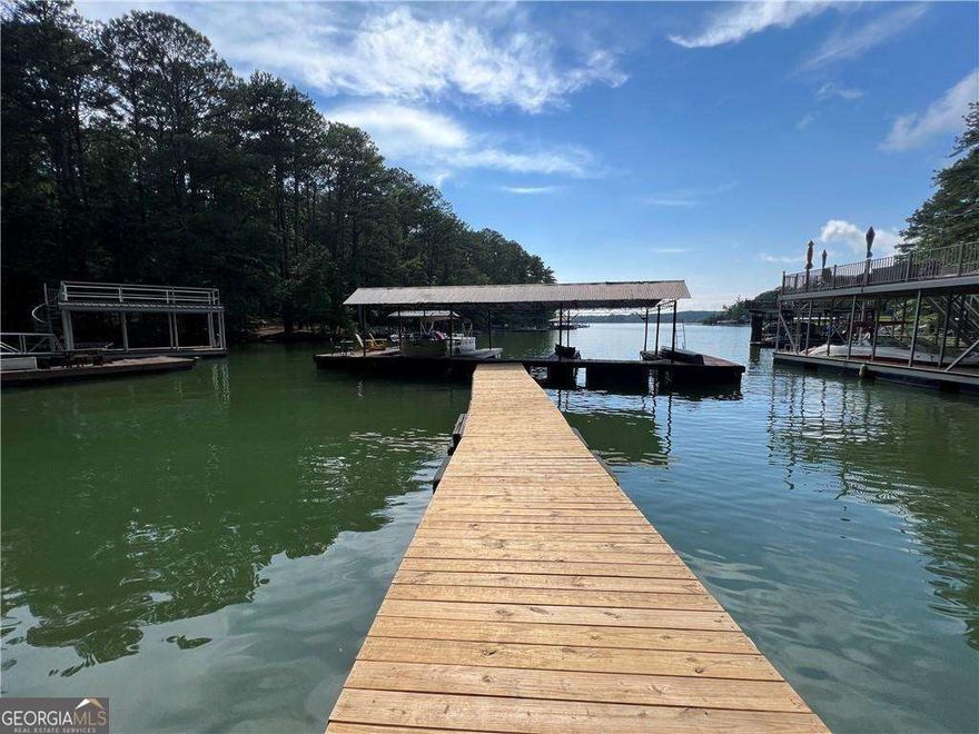 Discover the perfect opportunity to build your dream lake retreat at 812 Willow Oak Drive, Lot #15 - a beautiful and buildable lot with a rare deeded boat slip on Lake Allatoona! Nestled in a quiet, established community, this gently sloping property offers privacy, convenience, and direct access to one of North Georgia's most sought-after lakes. The lot features a natural wooded setting and a level building site ideal for a basement or ranch-style home. Simply cross the street and follow a short wooded path to your own covered dock slip, where you can spend weekends boating, fishing, or relaxing on the water. Enjoy the serenity of the forest canopy while still being just minutes from marinas, parks, and all the outdoor recreation Lake Allatoona is known for. With easy access to I-75, Canton, and Cartersville, this location combines lakeside tranquility with convenience. Whether you're envisioning a full-time residence or the perfect weekend getaway, this property offers a rare chance to build your custom home and enjoy lake life all year long. Don't miss this incredible opportunity-lots with deeded dock access on Lake Allatoona are truly hard to find!