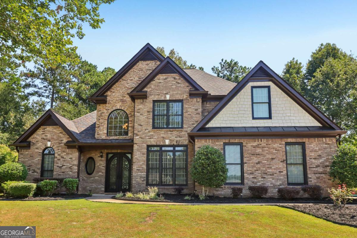 Welcome to this stunning European-style executive home, masterfully designed and truly in a league of its own! Tucked away in a picturesque cul-de-sac within the sought-after Whitestone Subdivision, this home boasts undeniable curb appeal with timeless architecture, manicured landscaping, and a sophisticated presence sure to turn heads. Step through the custom steel front door into a dramatic two-story foyer highlighted by wainscoting, majestic crown molding, elegant arches, and columns. Natural light pours in, accentuating the home's fine craftsmanship and open-concept design. This well-maintained 4-bedroom, 2.5-bath one of kind beauty offers a thoughtfully designed layout! Owner's suite on the main level with spa-like bath, whirlpool tub, tiled shower, dual vanities, and oversized walk-in closets. Three spacious secondary bedrooms upstairs, including a Jack-and-Jill bathroom with double vanities. Gourmet chef's kitchen with granite countertops, abundant cabinetry, walk-in pantry, and a cozy keeping room with fireplace. Formal dining room with soaring 10-foot ceilings, perfect for entertaining. Inviting family room featuring a stacked-stone fireplace and seamless flow to the private backyard retreat. Additional highlights include hardwood flooring, abundant storage, and a side-entry 2-car garage. Beyond the home, enjoy a vibrant community with resort-style amenities-walking trails, pool, tennis, clubhouse, playground, and more-all just minutes from shopping, dining, and conveniences. This home checks every box; luxury, comfort, and location! Don't miss your chance. Schedule your tour today!
