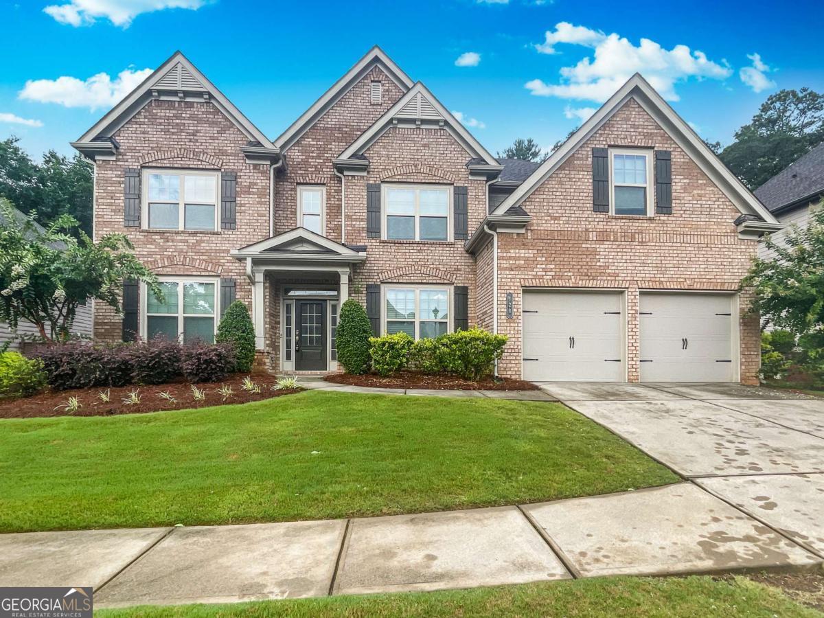Available September 10th! Beautiful, feature rich 5BR home near downtown Woodstock. Dramatic 2-sty entry Foyer w/Living Rm to the left and a bright Dining Rm rt w/Trey Ceiling and Wainscoting. Ahead is a huge, 2-sty Great Rm w/Stone FPLC, Built-in Bookcases and open views to the Breakfast and Kitchen areas. Kitchen has a lg Bkfst Counter Island, Abundant Cabinets, Walk-In Pantry, SS Appliances and more. Sunroom is adjacent the Kitchen too. This level also boasts Hardwood Flrs in all public areas. a BR on Main, Full Bath and an Office, Mudroom w/Cabinets and a 2-Car Garage. Upstairs are 4 more BR's for a total of 4BR's. Two share a Jack n'Jill Bath and One BR w/pvt Bath. One of the largest Master Suites you've ever seen w/Huge BR and Huge Sitting Area. The Master Bath includes a Walk-In Closet, Dbl Vanities, Garden Tub, Tiled Shwr w/bench and access to the Laundry Room. Wait, there's more - the Patio has a 2nd Fireplace!