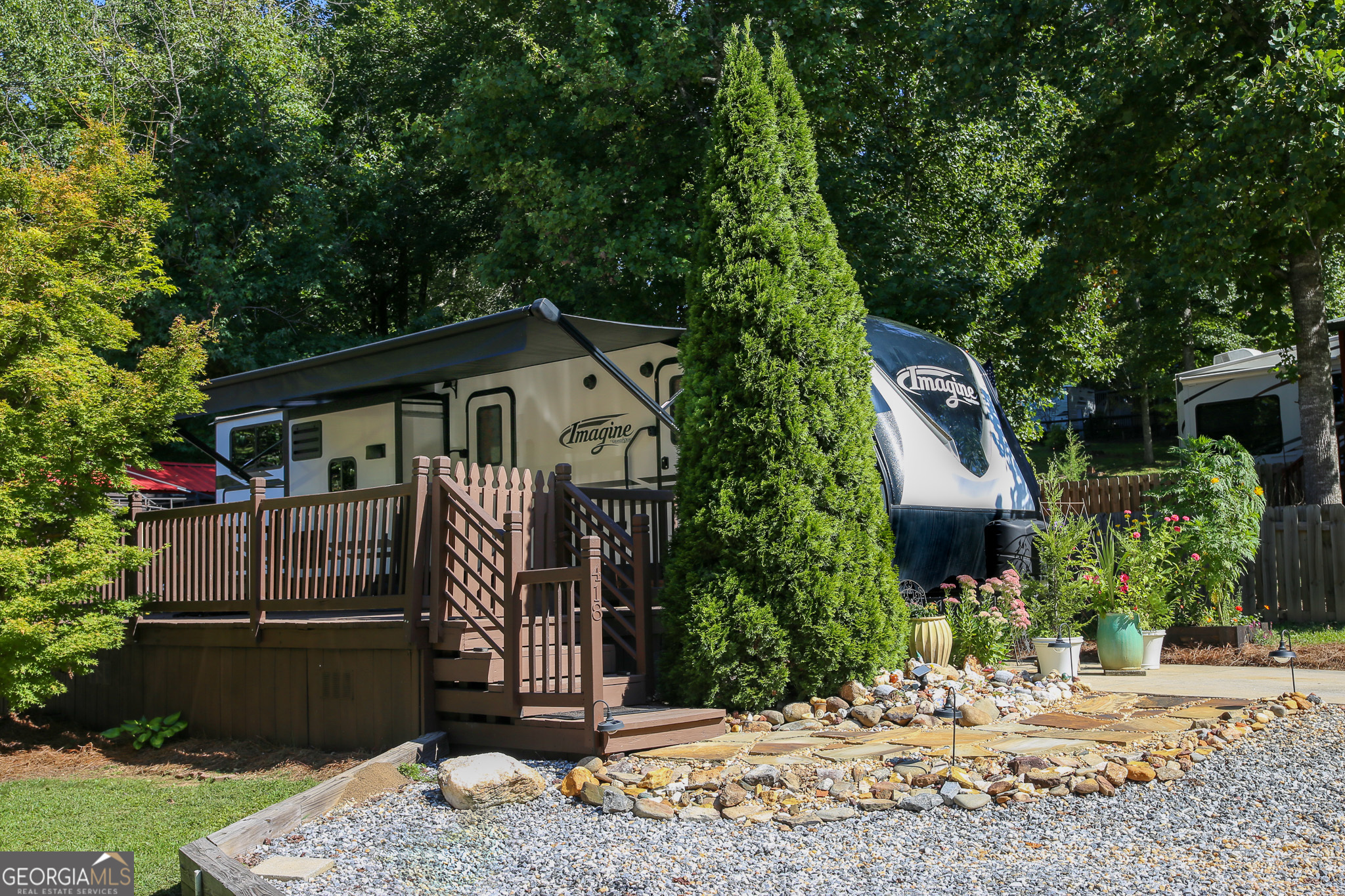 Discover Your Ideal Vacation Getaway or Full-Time Living in the North Georgia Mountains! This vacant lot in highly sought-after gated Elkmont community offers the perfect blend of relaxation and convenience. This spacious front deck/porch is ideal for grilling, entertaining, or simply enjoying the peaceful mountain views. The community offers amenities including a pool and provides easy access to schools, shopping, and dining. Just minutes from Helen, local wineries, and picturesque hiking trails, this is the perfect spot to create lasting memories. Whether you're looking for a vacation retreat or to downsize into full-time mountain living, this property is ready for you!**RV is not included.