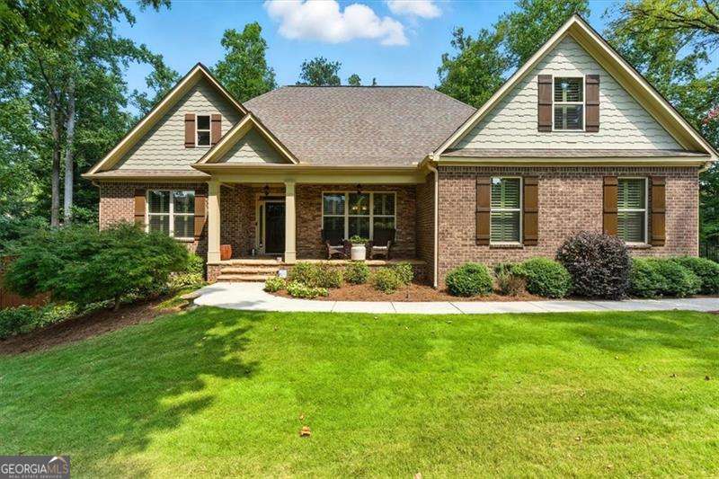 Luxury Home nestled in Hickory Flat, this home is located in Bradshaw Glen, a private 31 home community. This home has spacious main-floor living in addition to a finished terrace level with a full kitchen, and your own private backyard oasis featuring a stunning saltwater pool with three waterfall features. You'll feel at home the moment you step inside from the rocking chair front porch. You'll be impressed by the spacious, open floor plan. The sun-filled great room boasts custom built-in bookcases and a direct-vent fireplace, seamlessly flowing into the chef's kitchen with a large island, perfect for entertaining or casual dining. You'll love the abundant counter space, plentiful cabinetry, stainless steel appliances, and a butler's pantry ideal for extra storage or a coffee bar. A bright breakfast nook and formal dining room provide options for both everyday meals and family gatherings. Extend your entertaining outdoors to the covered back deck retreat, complete with an uncovered area perfect for grilling. This desirable split-bedroom plan includes a private primary suite with a spa-like bath featuring a large double vanity, tiled shower, soaking tub and oversized walk-in closet with direct access to the laundry room. Two additional bedrooms and a full hall bath complete the main level. Upstairs, discover two more spacious bedrooms, a cozy sitting area, a hall bath with a double vanity and large walk in shower and a media room (that can also be used as a bedroom) designed for movie nights or family fun. The terrace level offers a potential in-law suite with its own living room, full kitchen (refrigerator, stove, dishwasher, and microwave) with a large island, dining area, full bath with tiled shower, an office/exercise room, unfinished storage, and a workshop with plenty of space for equipment. Step outside to your private backyard retreat with lush landscaping and your sparkling gunite/pebble tec saltwater pool - you may never want to leave home! Additional highlights include a 3-car garage, excellent school district, and convenient location close to shopping with easy access to GA400 and I575. Don't wait - this dream home won't last!
