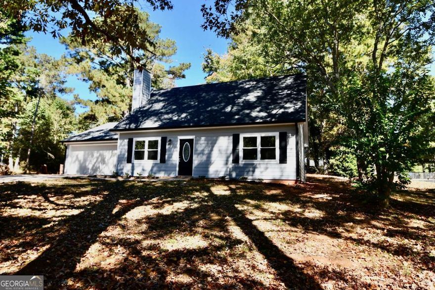 Adorable updated cottage home  on large wooded corner lot with fenced yard!  New roof, HVAC, paint, flooring, lighting, kitchen with all new appliances and sold surface tops,  3 bedrooms and two full baths, fireplace in the great room, primary on main level, and two additional bedrooms and bath up.