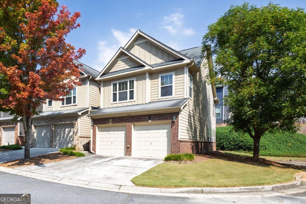 Welcome to this move-in-ready townhome located in the Highlands at Booth's Farm. This beautifully maintained 3-bedroom, 2.5-bath home features a 2-car attached garage and is nestled in a gated community offering resort-style amenities including a swim area and cabana. Step into a bright two-story foyer where elegant arched entryways lead to an open-concept floorplan, perfect for modern living. The living room and bedrooms feature brand new carpet, while the kitchen, foyer, dining room, and sunroom showcase rich hardwood flooring. The inviting family room centers around a cozy fireplace flanked by custom built-ins. The well-appointed kitchen boasts 42" cherry cabinets, stainless steel appliances, and hardwood floors. Upstairs, you'll find a spacious primary suite complete with a sitting area, vaulted ceilings, an oversized walk-in closet, and a luxurious bath with double vanities, a garden tub, and separate shower. Two generously sized secondary bedrooms share a full bath and are conveniently located near the laundry room. Enjoy quiet evenings on your private back patio. This end unit townhome sits in a quiet cul-de-sac adjacent to the overflow visitor parking. With exterior maintenance, landscaping, and trash removal included in the HOA, you can truly enjoy low-maintenance living just minutes from Downtown Marietta, shopping, dining, and quick access to I-75. Don't miss this opportunity to own in a prime location with exceptional value!