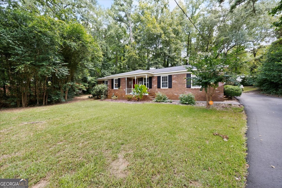 Welcome to 4775 Cheryl Ann Drive, a charming and well-maintained 3-bedroom, 2-bathroom brick ranch nestled in a quiet North Macon neighborhood. With 1,223 square feet of living space and nearly an acre of land, this home offers comfort, updates, and room to grow. Step inside to find original hardwood floors, fresh interior paint, and a smart layout designed for everyday living. The living room flows into a separate dining area, while the kitchen offers ample cabinet space, natural light, and a cozy breakfast nook. The primary suite features a private full bath and generous closet space. Two additional bedrooms provide flexibility for guests, kids, or a home office. This home comes with major upgrades already done for you - including a new roof, new HVAC system, and a freshly paved driveway, adding value, peace of mind, and great curb appeal.