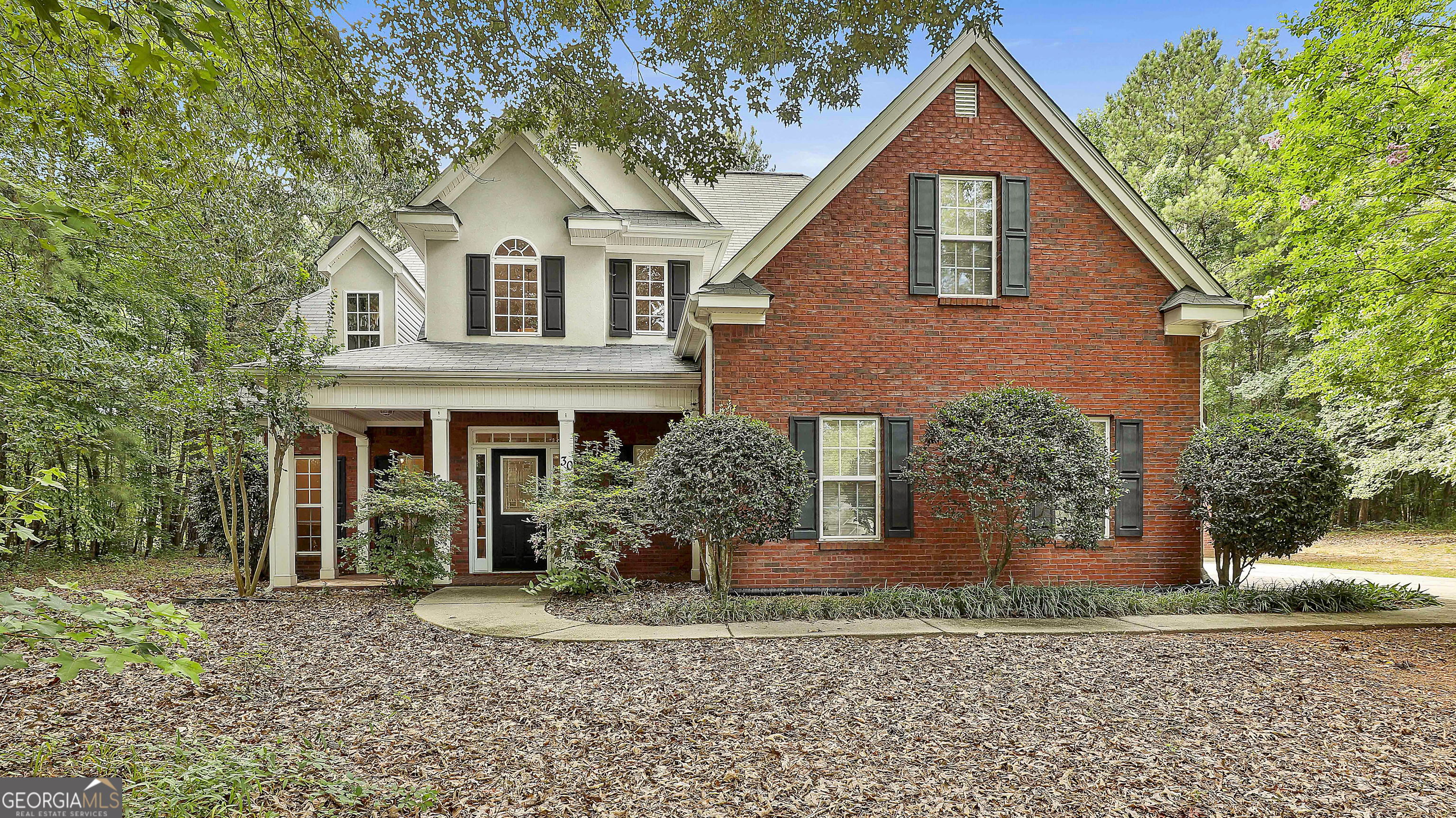 **Spacious Brick-Front Beauty with Master on Main & Exceptional Outdoor Living** Welcome to this beautifully maintained 4-bedroom, 2.5-bath brick-front home that combines classic charm with modern functionality. From the moment you enter the dramatic two-story foyer, you'll be greeted by soaring ceilings, a graceful staircase, and a layout designed for both everyday living and elegant entertaining. The main-level primary suite offers a peaceful retreat with a spa-inspired bath featuring a soaking tub, separate shower, and double vanity. The formal dining room provides the perfect setting for special occasions, while the cozy family room invites you to relax by the fireplace. The kitchen boasts quartz countertops, a spacious breakfast area, pantry, and ample cabinet storage-ideal for both meal prep and gathering with loved ones. Upstairs, you'll find three additional bedrooms and a full bath, offering comfort and privacy for family or guests. Step outside to enjoy exceptional outdoor living with a wrap-around patio, partially wooded lot, and a raised garden bed complete with its own irrigation system. The home also includes a two-car attached garage plus a detached two-story garage, which functions more like a flexible outbuilding-with the upper level perfect for a home office, studio, or playroom. A parking pad and driveway offer additional space for multi-vehicle households or gatherings. Additional highlights include a new water heater, high ceilings throughout, and a thoughtfully designed floor plan that suits a variety of lifestyles. Don't miss your chance to own this inviting and versatile home that truly has it all.