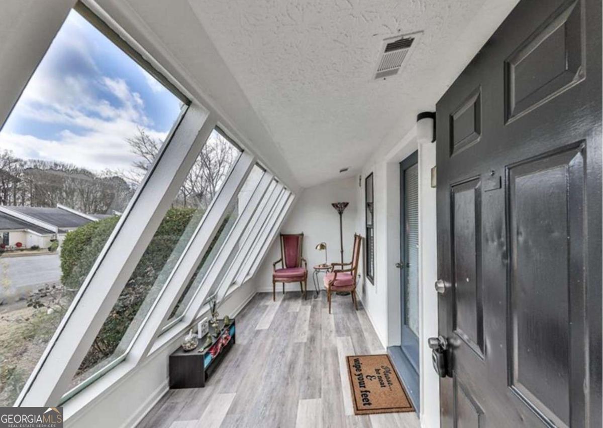 Discover the epitome of modern living in this charming home nestled near downtown Woodstock. Boasting 3 bedrooms on the main floor and it's own laundry room, this residence exudes contemporary elegance and practical design. Ascend the captivating spiral staircase to unveil a separate loft area, complete with a closet, offering a versatile space that can be customized to fit your lifestyle. Embrace the allure of outdoor living in your private fenced-in yard, providing an intimate retreat for relaxation and entertaining. Immerse yourself in the sense of community with access to a community pool, perfect for enjoying sunny days with family and friends. This home not only offers a tranquil haven but also places you in close proximity to the vibrant heartbeat of downtown Woodstock. Explore the local shops, indulge in culinary delights at nearby restaurants, and experience the cultural richness of this thriving community. With a perfect blend of comfort, style, and convenience, seize the opportunity to make this attached home your ideal sanctuary near the heart of Woodstock.