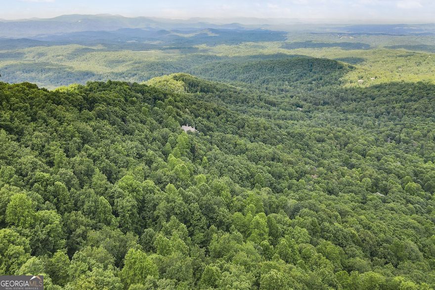 This prime 2+ acre property in Big Canoe is surrounded by beautiful homes and offers stunning views, making it an ideal location for building your dream home or investment property.  Big Canoe is a vibrant gated community in the Blue Ridge Mountains, featuring over 20 miles of hiking trails, multiple lakes for boating and fishing, a championship 27-hole golf course, tennis courts, wellness center with spa and fitness facilities, and exclusive dining options.  The area is perfect for vacation rentals, including Airbnb, due to its plethora of amenities such as beach club with a rockslide, swimming pools, and over 50 community clubs.  This property is not only a serene retreat but also a fantastic investment opportunity.