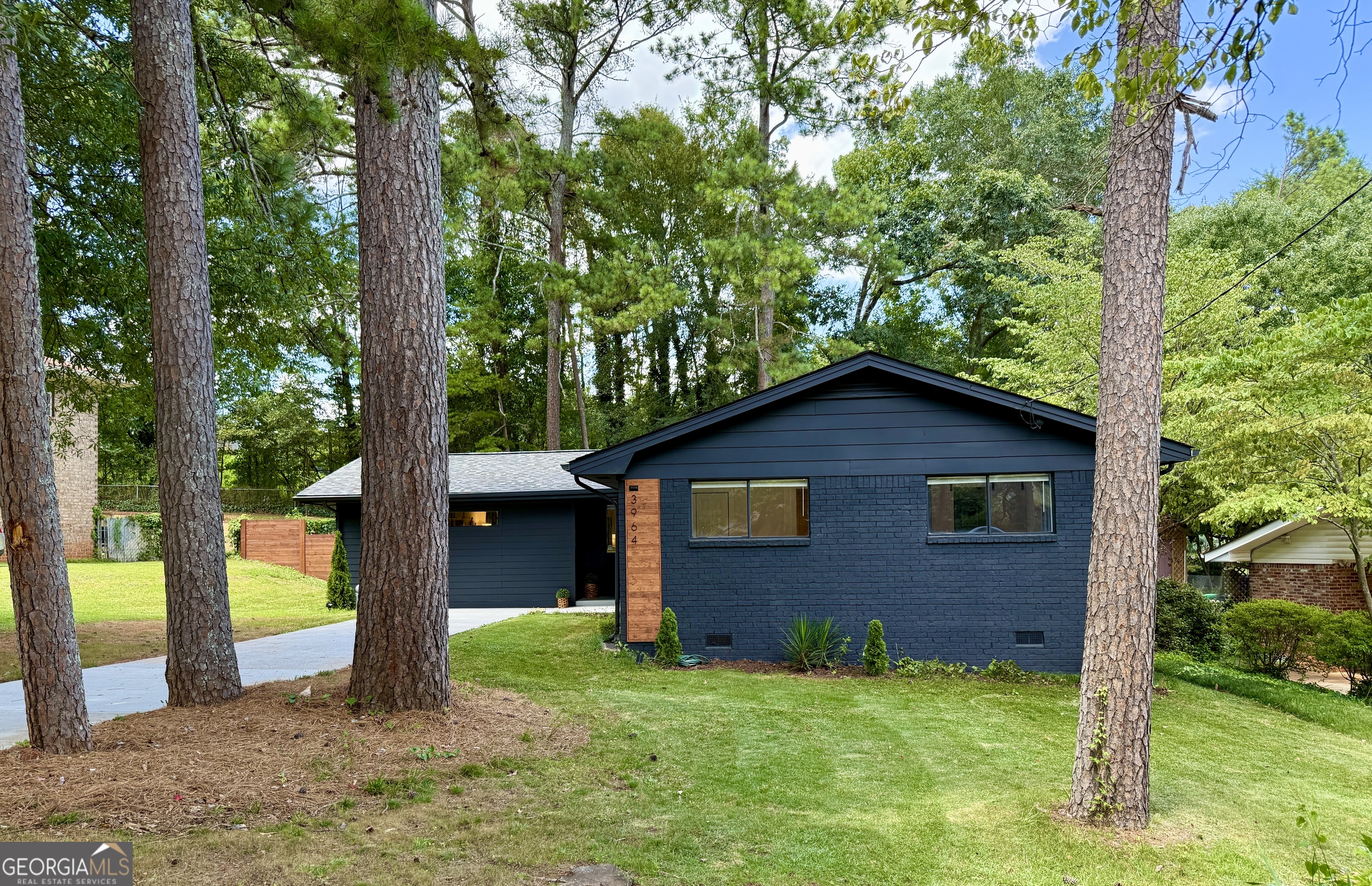 BUYER INCENTIVE! Seller is offering $10,000 toward buyer's closing costs with an accepted offer. Credit can be applied to closing costs or used toward a mortgage rate buy-down to help reduce monthly payments. 3964 Gretna Green Drive, a beautifully remodeled 4 bedroom, 2 bathroom home nestled in Atlanta's vibrant Glenwood estates neighborhood. This home boasts an expansive floor plan providing ample room for relaxation and entertainment. 2025 renovations included, new roof, new A/C, new hardwood flooring, new LED lighting, new updated kitchen with new cabinetry, quartz counters, new SS appliances, updated bathrooms with new vanities, luxurious showers and interior and exterior painting. Freshly landscaped front yard with private fenced in backyard and deck/patio area. Within minutes of popular dining neighborhoods in Kirkwood, Oakhurst, downtown Decatur and Dekalb Farmers Market. Super convenient location near major interstates and less than 20 minute commute to Hartsfield-Jackson International Airport. Experience the perfect blend of modern updates and urban convenience at 3964 Gretna Green, a place to call home.