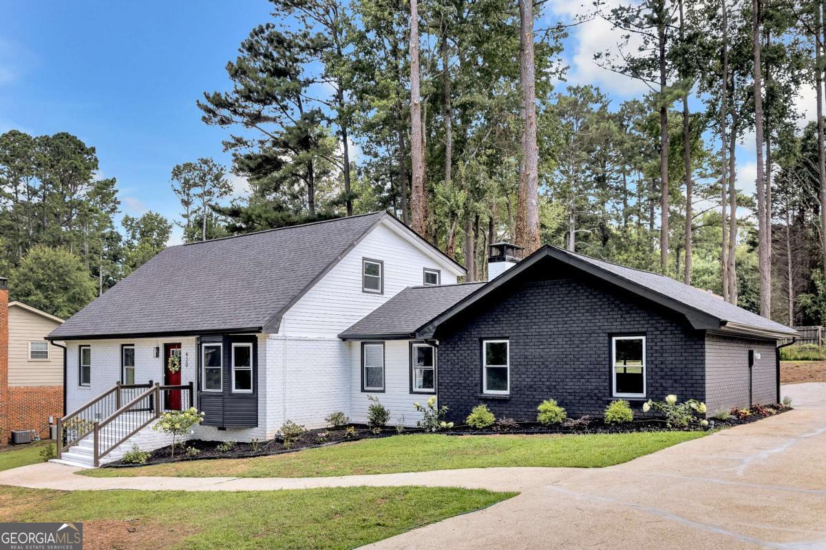 Where Lifestyle Meets Location. Discover this beautifully renovated 4-bedroom, 2-bath home blending modern design and smart functionality, everything you're looking for in Cobb County. Inside, you'll find a spacious open-concept layout that seamlessly connects the kitchen and family room, which features a cozy fireplace, perfect for relaxing nights or entertaining guests. The kitchen has been fully updated with quartz countertops, stainless steel appliances, stained cabinetry, and sleek new fixtures. A separate dining room and an additional flex space provide versatility for a formal living room, home office, or playroom. The primary suite is thoughtfully located on the main level, separate from the secondary bedrooms for added privacy. It features generous closet space and a stylishly updated bathroom. A convenient mudroom off the garage offers the perfect drop zone for daily living, ideal for busy families or pet lovers. Throughout the home, enjoy brand-new LVP flooring, fresh interior and exterior paint, new quartz countertops, new appliances, and updated lighting and plumbing fixtures. Additional upgrades include a NEW ROOF, NEW WINDOWS, NEW HVAC, NEW WATER HEATER and a new garage motor, ensuring peace of mind and true move-in readiness. This beautifully updated home sits on a quiet street just minutes from I-285, parks, shopping, and top-rated Cobb County schools. Don't miss your chance, schedule your private tour today!