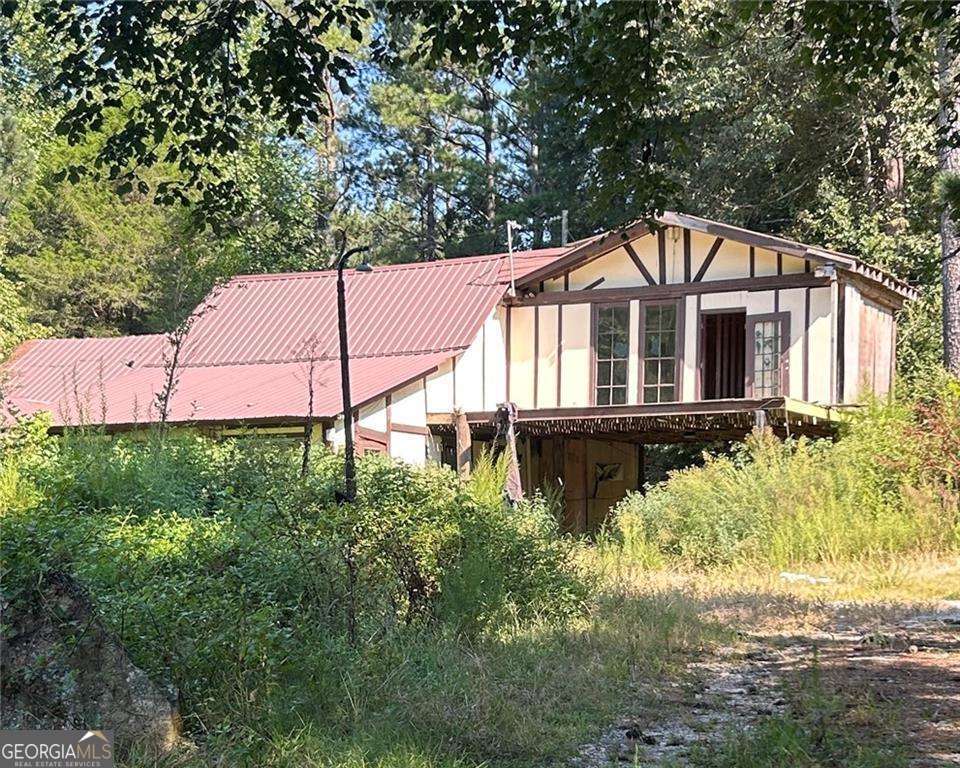 This is an investor's dream! CASH ONLY, the property, which has 2 bedrooms, 1.5 bathrooms, and a 1-car garage, is located on about 6.9 acres of land with a pond! The road frontage measures about 1,460 feet. There is definitely high potential for expansion and improvement. So, if you're looking to fix and flip, or you've always wanted land to build on, this might be the perfect project for you. Property needs major renovations, but it has lots of potential for an Investor like a new project. Property is located on a developing area it has lot of new construction nearby.