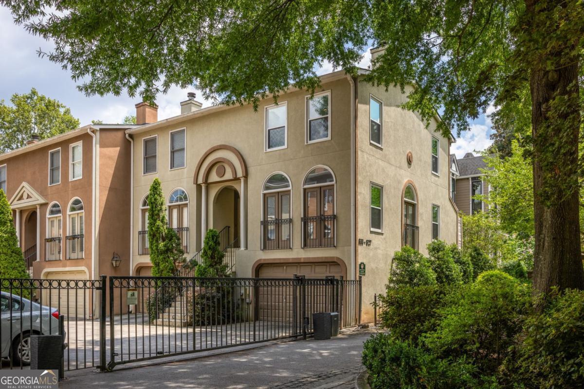 Located in the heart of Midtown, this lovely townhome within the peaceful Piedmont Villas community, is an offering that rarely comes available. As an end unit, this townhome boasts windows on three sides, in addition to skylights, providing abundant and beautiful natural light throughout. The main level features an open and bright layout with a living space anchored around a fireplace, clean and bright kitchen with breakfast bar, and rear french doors which lead out to a private deck. Additionally, there are three bedrooms - all of which have their own ensuite baths. The terrace level has many possibilities including serving as a guest room, office, or fitness room. Generous and wide garage space provides ample storage in addition to secure parking with additional parking available in front of the garage. Within the Virginia Highland Elementary school district and centrally located, this home offers convenience to Piedmont Park and everything Midtown has to offer, all while remaining tucked away within a small and serene community - truly the best of both worlds. Freshly painted throughout and windows have been recently replaced providing added efficiency along with peace of mind. Piedmont Villas is a gated community with fee simple ownership, very low HOA dues, and no rental restrictions - providing additional opportunity and value should the need or desire ever arise. These homes rarely come to market - come see why the residents of Piedmont Villas love calling this special community with prime location home.
