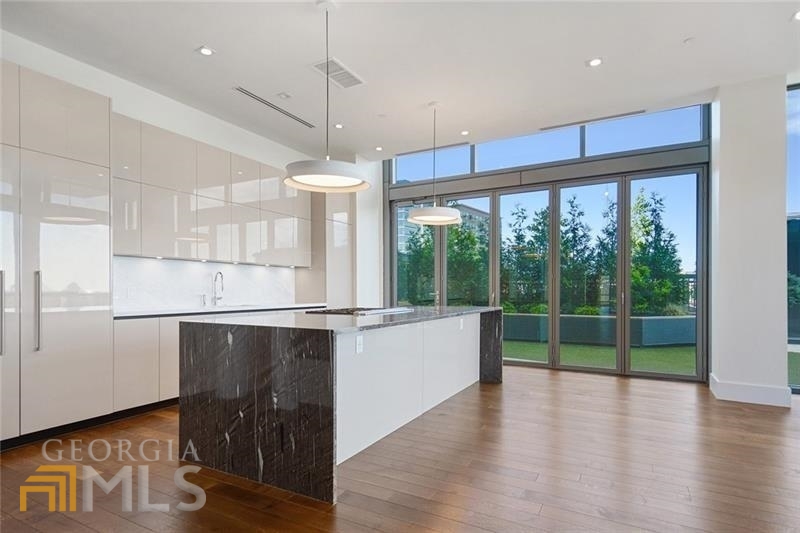 Gorgeous unit in The Charles is a one of a kind condo that combines two units to create a spacious four bedroom floorpan. Located on the amenity level has unit offers private terrace or garden patio for all 4 bedrooms. The Nanawall folding door system creates a seamless transition from indoor to outdoor, ideal for entertaining. Sleek and sophisticated kitchen with waterfall marble counter island and all Gaggenau appliances. 1,000 bottle gallery wine wall with state of the art climate control, a full wet bar with ice maker, refrigerator & dishwasher. Living room has gas fireplace and floor to ceiling windows. Private study has built-in bookcases and French iron doors. Oversized master with sitting area, dual walk-in custom closets. Luxurious spa-like master bath with double vanities, separate shower and Victoria Albert soaking tub. Four car private enclosed garage with storage unit and private access to the elevator. The Charles offers exceptional amenities including saltwater pool, fitness center, stunning club room, fire pits and dog walk. The Charles also has doorman/valet, security guard and concierge.