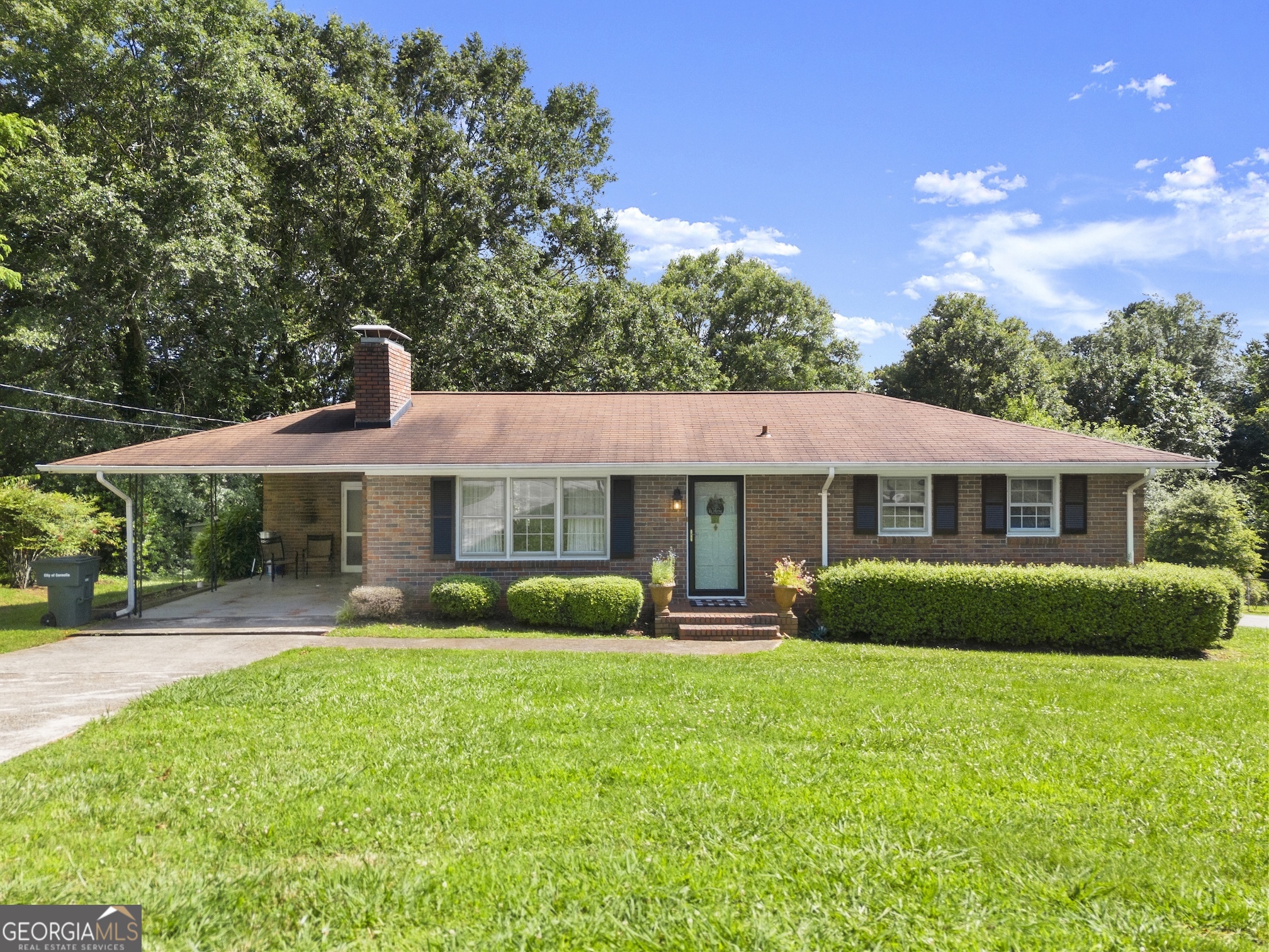 Ever popular and hard to find, one-level brick ranch located on a corner lot in Cornelia's Tower Mountain neighborhood. Enter into the large living area with hardwood floors and fireplace with built-in bookcases as the main focal point and plenty of windows that allow natural light to course through the space. Open concept dining and kitchen area with views of the large backyard. The kitchen has been recently updated with shaker style cabinets, solid surface counters and subway tile backsplash. The Owner's Suite is complete with full attached bath - a large second bedroom and full bath in the hall are perfect for guests. Oversized laundry room that offers bonus storage space. Venture outside to check out the corner lot, large backyard and attached carport parking. Schedule your private tour today!