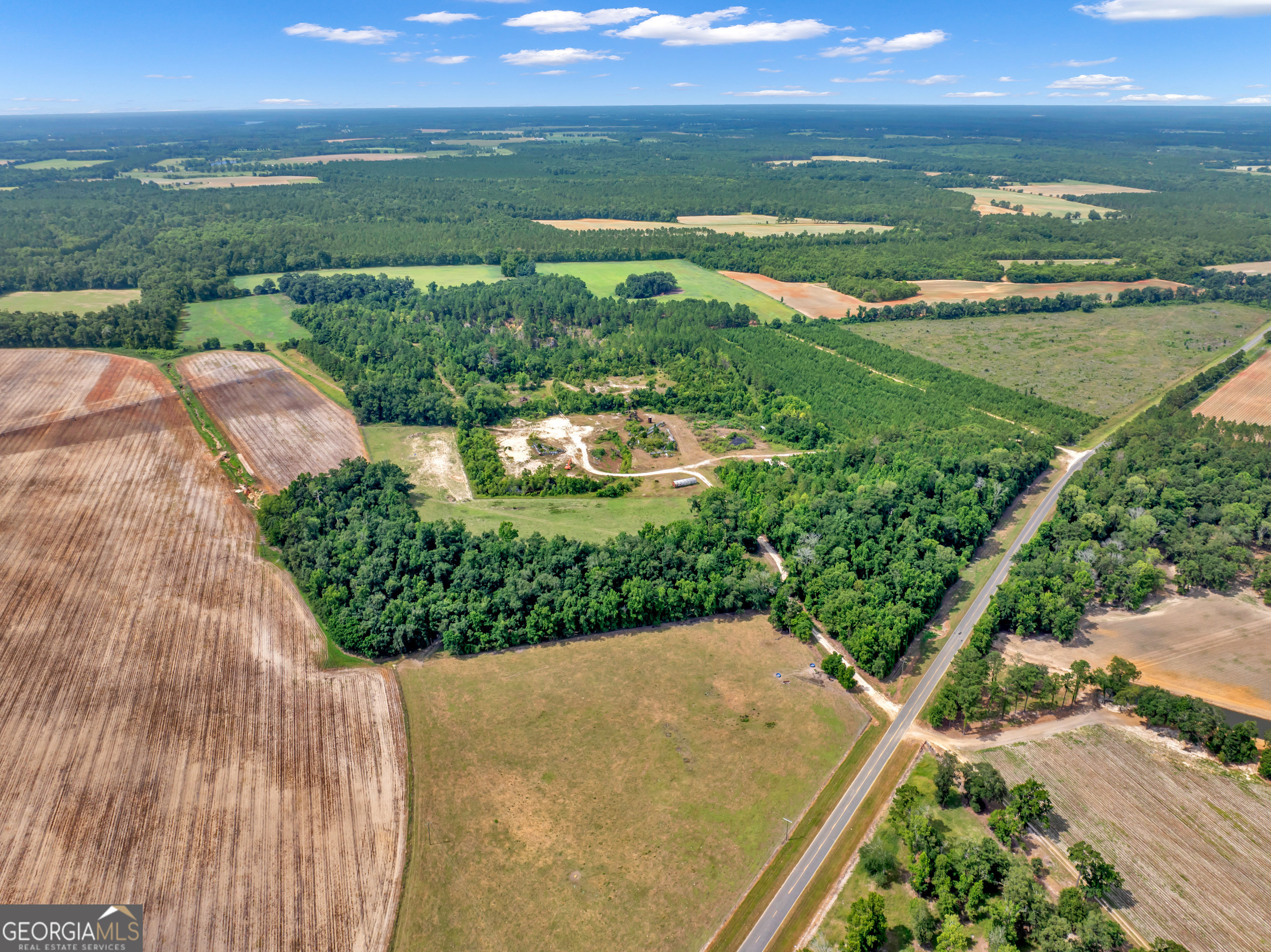 Grady Aggregate is a high calcium facies of the Suwannee Limestone, typically averaging in excess of 98% calcium and magnesium carbonate with minute mineral contaminates. Drilling programs conducted indicate a reserve base of 14.8 million cubic yards (27.6 million tons) of total limestone existing from 40 feet below the water table to top of the rock. Approximately 9.8 million cubic yards (19.6 million tons) are above the water table and are recoverable under the condition of the mining permit issued by the State of Georgia. The permit can be modified to accommodate under water mining as confirmed by the Surface Mining Division of EPA in Atlanta. The total limestone volume (30,000,000 million tons) lies beneath an average of 26 feet of overburden on 70 acres. Grady Aggregate will mine from the Suwannee Formation at its operation in Grady County, Georgia. The stone is a tan-white to white fine grain fossil ferrous high calcium limestone with varying degrees of induration (hardness). Typically, the stone becomes whiter and softer at depth. Core drilling has indicated this relationship to be present throughout the ore body. Because of the varying degrees of relative hardness and color, stone from this quarry will support a wide spectrum of varying markets.