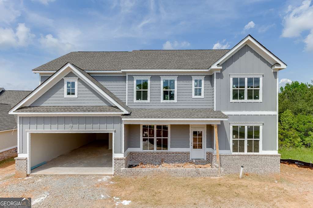 "LOT 159Q/JACKSON PLAN" Another impressive home in Traditions of Braselton by Hillgrove Homes! This floorplan boasts 5 bedrooms, 4 full baths and has all the designer touches. The spacious Gourmet Kitchen w/ oversized island overlooks the inviting Family Room. Coffered ceilings, shiplap, brick fireplace, cedar mantle and built-in cabinetry complete this space. The Kitchen features custom painted cabinetry w/ soft-close drawers, quartz or granite countertops, stainless steel appliances, tile backsplash, farm sink and spacious walk-in pantry. A Dining/Office/Flex Space and Study right off the Foyer boasts an extensive trim package. The oversized Primary Suite & Primary Bath add SO much space to this home and are complete with an oversized super shower and soaking tub, upgraded cabinetry and countertops, dual sinks and upgraded tile. Large secondary bedrooms (one full bed/bath on main level), closets & bathrooms are an extra perk. The covered back porch w/ fireplace is perfect for entertaining or back porch sitting! GOLF CART GARAGE! Sought-after Jackson County School System. Traditions of Braselton awards you swim/tennis/golf/restaurant/clubhouse/fitness facility and more. Endless activities for the amenity reach community seeker.