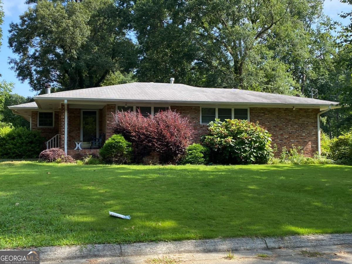 Investor Special - Brick Ranch on Level Lot (Sold As-Is) - Great opportunity for builders or renovators! This 3-bedroom, 2-bath brick ranch sits on a beautiful level lot with a private, fenced-in backyard and a storage shed. Spacious layout includes a fireside family room, formal dining room, large finished rec room, and kitchen with tile floors, built-in shelves, gas stove, range hood, dishwasher, and refrigerator. Features include: hardwood and tile flooring, newer windows, ceiling fans, covered patio perfect for entertaining, and a gorgeous backyard with plenty of green space. Convenient location with strong potential. Home is being sold as-is. Bring your vision and make it your own.