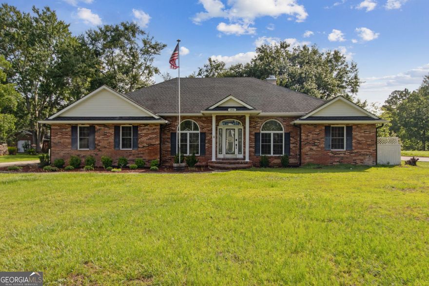 This house has so much character you'll just have to see it with your own eyes! Stunning 4 bedroom 2 bathroom all-brick home situated on 0.7 acres of easily maintainable yard. From the columns and brick steps leading to the front door, to the ready-to-customize front lawn, the curb appeal is limitless! Inside you're immediately greeted with hardwood flooring throughout, custom plantation shutters, crown moulding, and beautiful coffered ceilings. This home features a formal dining room, an office/den with amazing built-in bookshelves, and a spacious living room with a wet-bar and gas burning fireplace. The kitchen has granite counter tops, a breakfast bar, cabinets galore--plus an additional eat-in nook! Split bedroom floor plan with the primary suite off the kitchen, and the other 3 bedrooms across the living room. The primary bedroom provides plenty of natural light thanks to the large windows overlooking the backyard. Double vanities, a soaking tub, and a tiled shower, plus a great walk-in closet. Indoor laundry room, screened-in back porch that's great for enjoying the summer months without the bugs, 2-car garage with side entry, and an extended driveway. Low HOA fees that allow access to a private boat ramp and dock, all without required flood insurance! This home is just waiting for someone to come show it the love it deserves.
